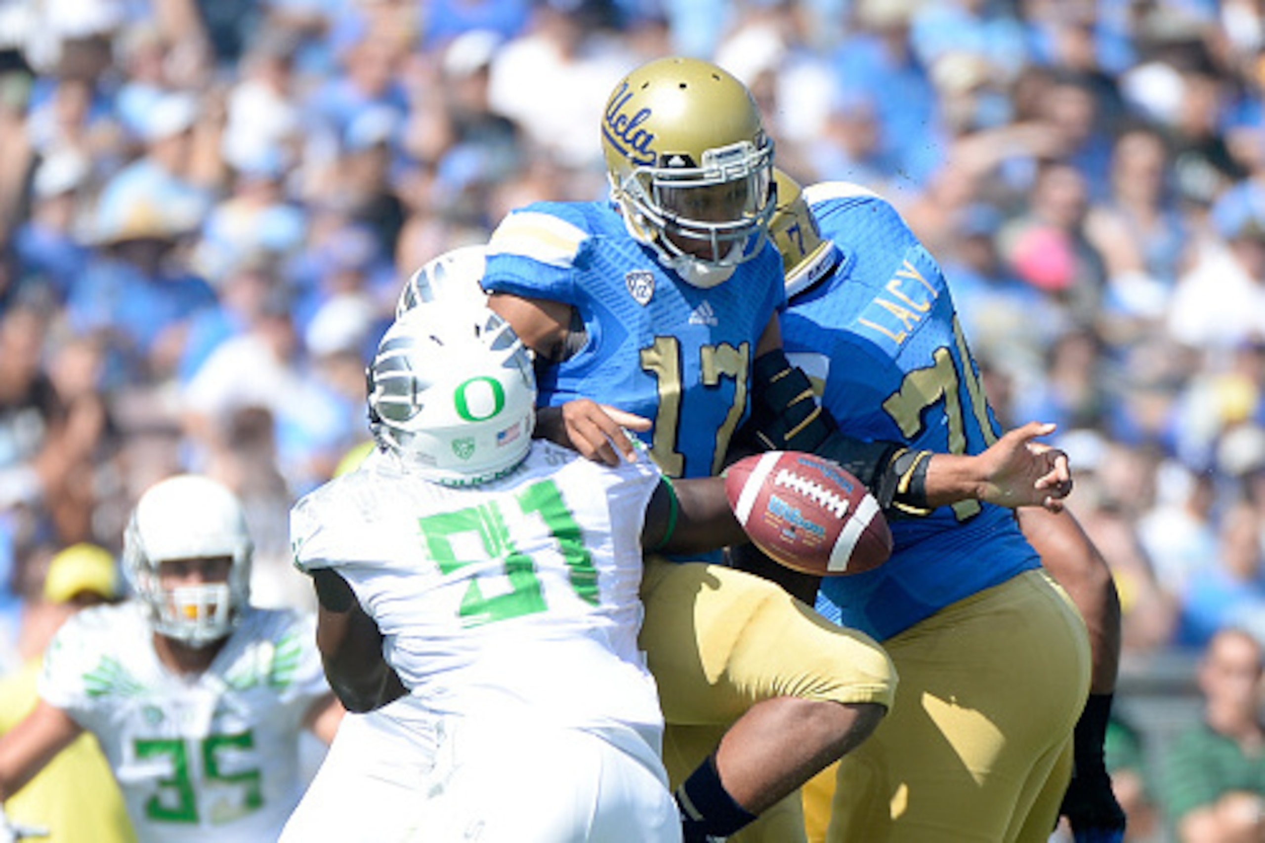 PASADENA, CA - OCTOBER 11: Brett Hundley #17 of the UCLA Bruins fumbles as he is sacked by Tony Washington #91 of the Oregon Ducks during the first quarter at Rose Bowl on October 11, 2014 in Pasadena, California. (Photo by Harry How/Getty Images) PASADENA, CA - OCTOBER 11: Brett Hundley #17 of the UCLA Bruins fumbles as he is sacked by Tony Washington #91 of the Oregon Ducks during the first quarter at Rose Bowl on October 11, 2014 in Pasadena, California. (Photo by Harry How/Getty Images)