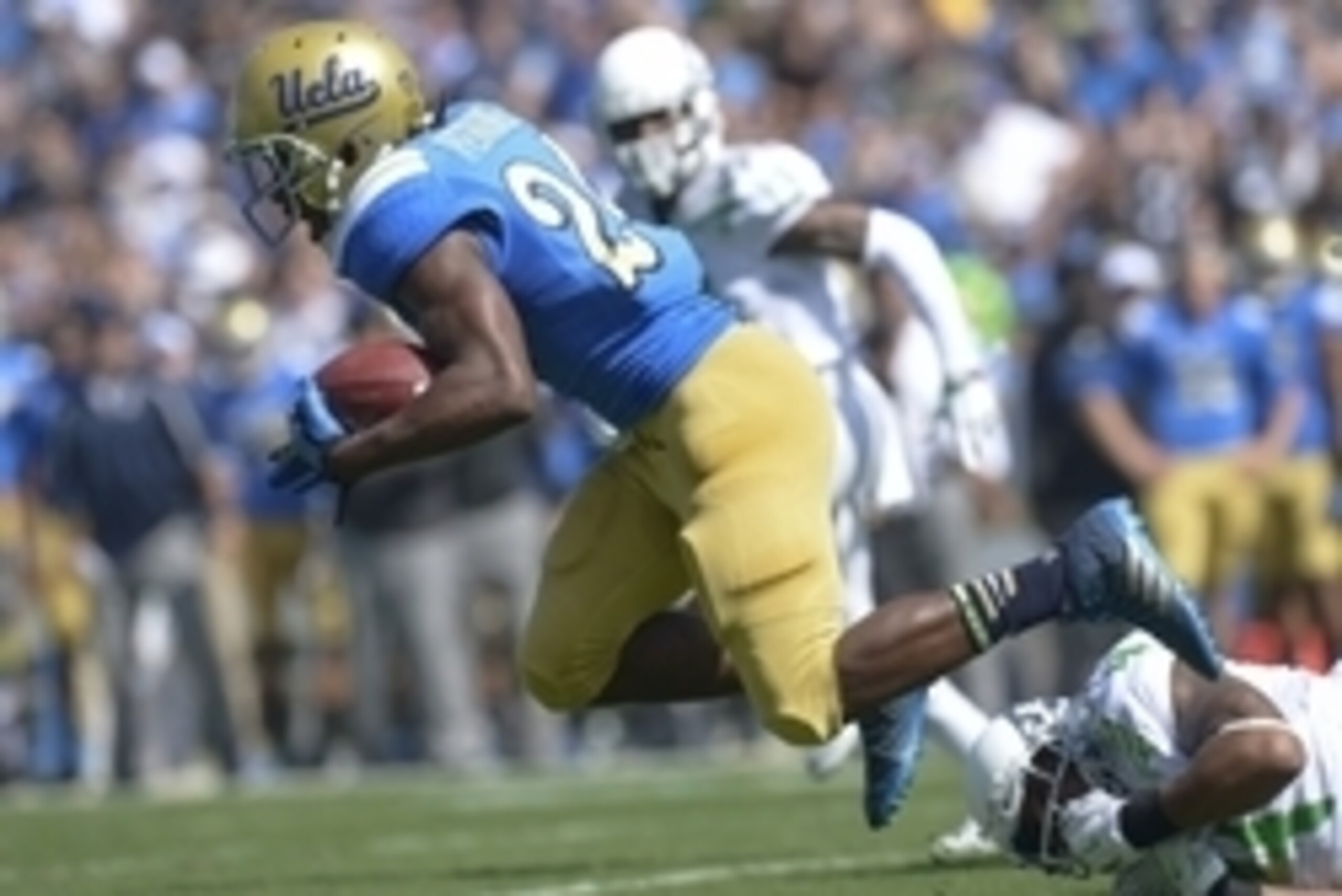 Oct 11, 2014; Pasadena, CA, USA; UCLA Bruins running back Paul Perkins (24) escapes the grasp of Oregon Ducks defensive back Erick Dargan (4) during first quarter action at Rose Bowl. Mandatory Credit: Robert Hanashiro-USA TODAY Sports Oct 11, 2014; Pasadena, CA, USA; UCLA Bruins running back Paul Perkins (24) escapes the grasp of Oregon Ducks defensive back Erick Dargan (4) during first quarter action at Rose Bowl. Mandatory Credit: Robert Hanashiro-USA TODAY Sports
