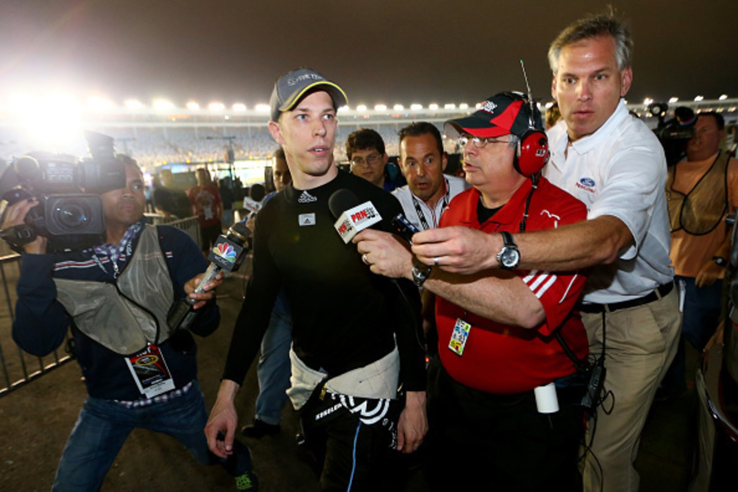 CHARLOTTE, NC - OCTOBER 11:  Brad Keselowski (second from left), driver of the #2 Detroit Genuine Parts Ford, speaks with the media after the NASCAR Sprint Cup Series Bank of America 500 at Charlotte Motor Speedway on October 11, 2014 in Charlotte, North 