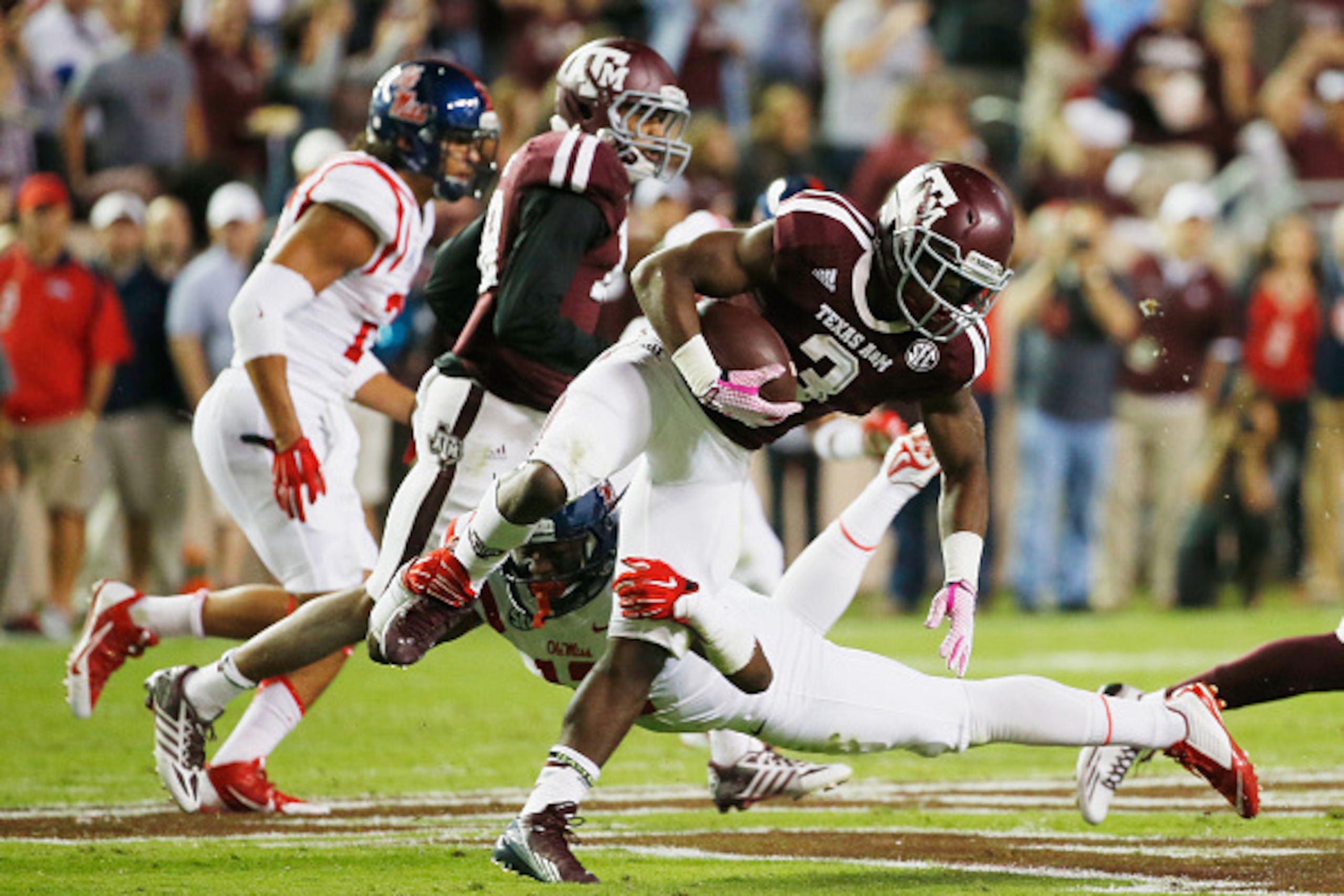 COLLEGE STATION, TX - OCTOBER 11:  Trey Williams #3 of the Texas A&M Aggies is tackled by Tony Conner #12 of the Mississippi Rebels during the first half of their game at Kyle Field on October 11, 2014 in College Station, Texas.  (Photo by Scott Halleran/