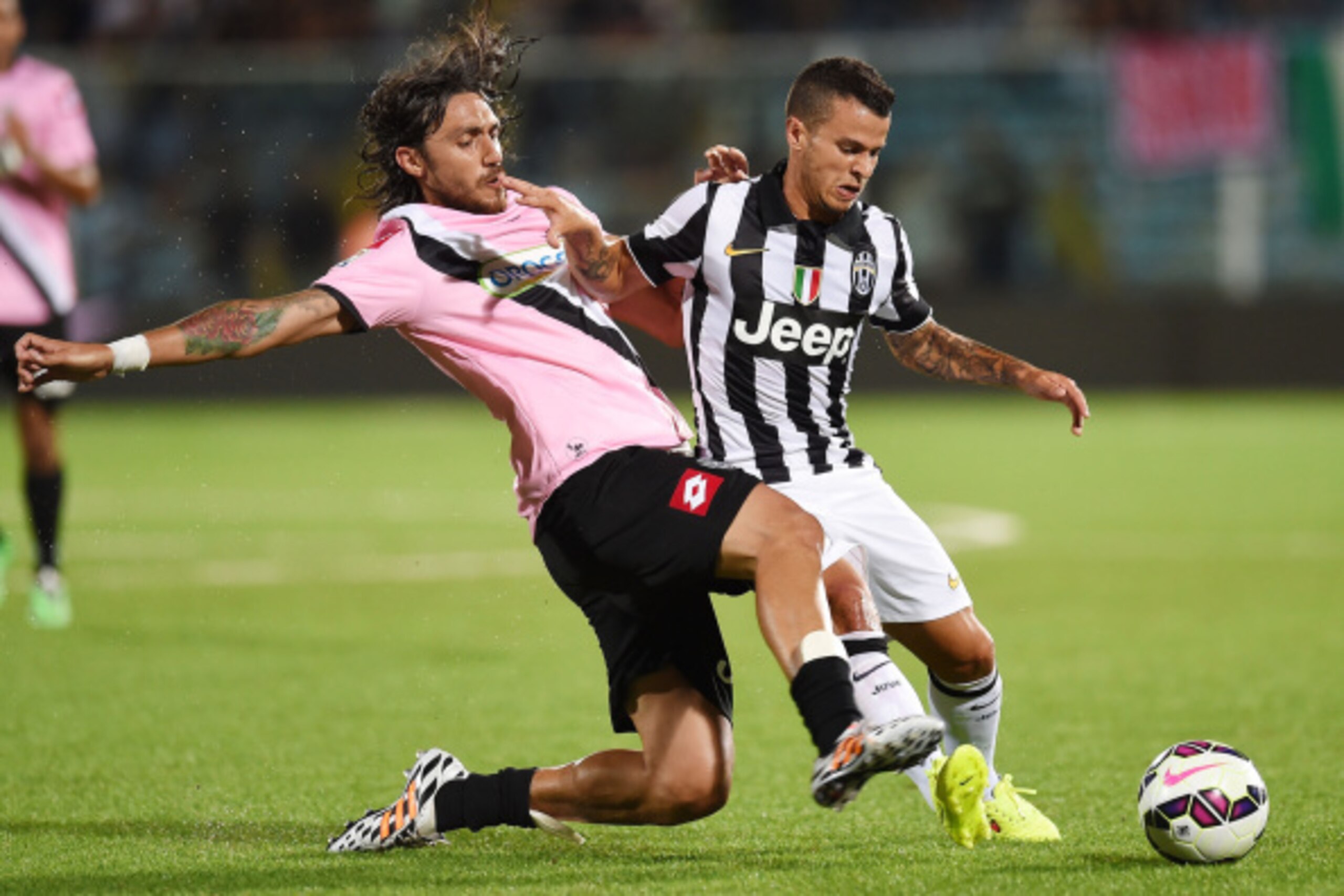 CESENA, ITALY - JULY 30:  Emmanuel Cascione of Cesena and Sebastian Giovinco of Juventus in action during the pre-season friendly match between AC Cesena and Juventus FC at Dino Manuzzi Stadium on July 30, 2014 in Cesena, Italy.  (Photo by Giuseppe Bellin