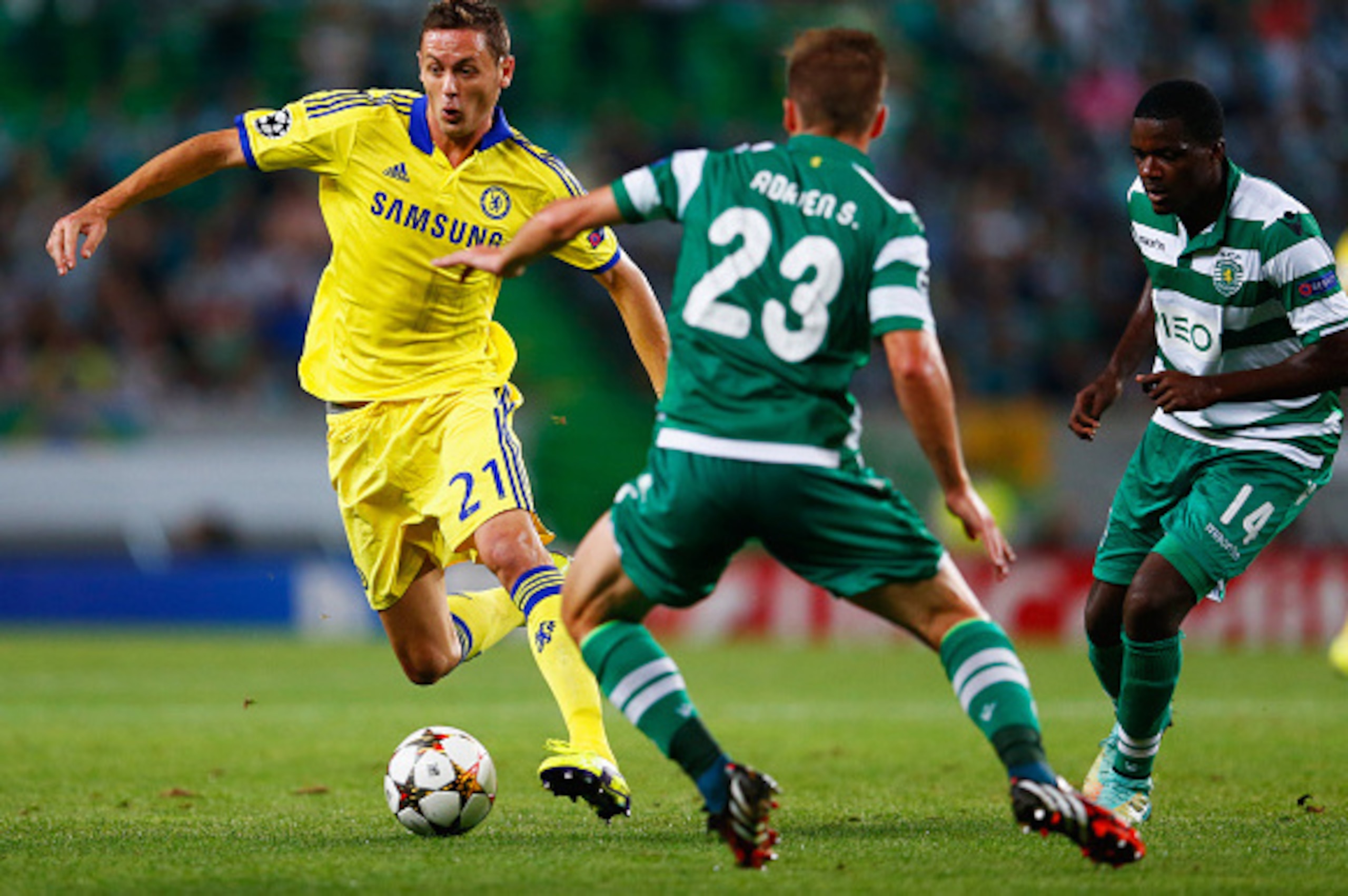LISBON, PORTUGAL - SEPTEMBER 30:  Nemanja Matic of Chelsea takes on Adrien Silva (23) and William Carvalho (14) of Sporting Lisbon during the UEFA Champions League Group G match between Sporting Clube de Portugal and Chelsea FC at Estadio Jose Alvalade on