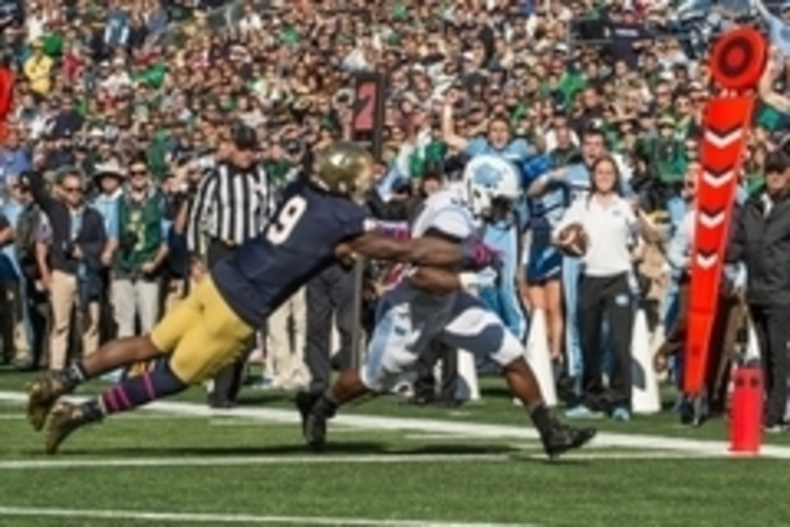 Oct 11, 2014; South Bend, IN, USA; North Carolina Tar Heels running back Elijah Hood (34) scores a touchdown as Notre Dame Fighting Irish linebacker Jaylon Smith (9) defends in the first quarter at Notre Dame Stadium. Mandatory Credit: Matt Cashore-USA TO