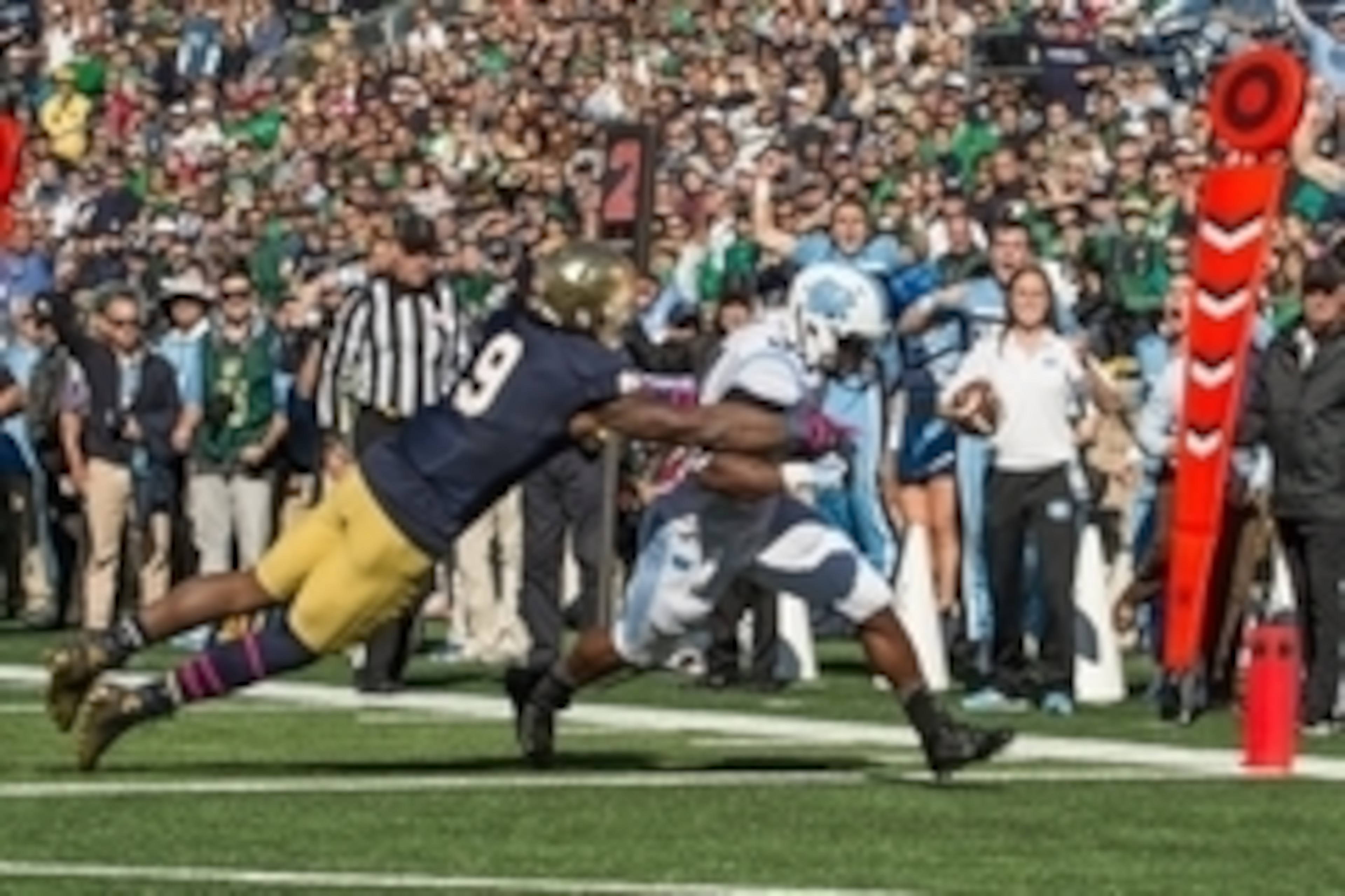 Oct 11, 2014; South Bend, IN, USA; North Carolina Tar Heels running back Elijah Hood (34) scores a touchdown as Notre Dame Fighting Irish linebacker Jaylon Smith (9) defends in the first quarter at Notre Dame Stadium. Mandatory Credit: Matt Cashore-USA TO