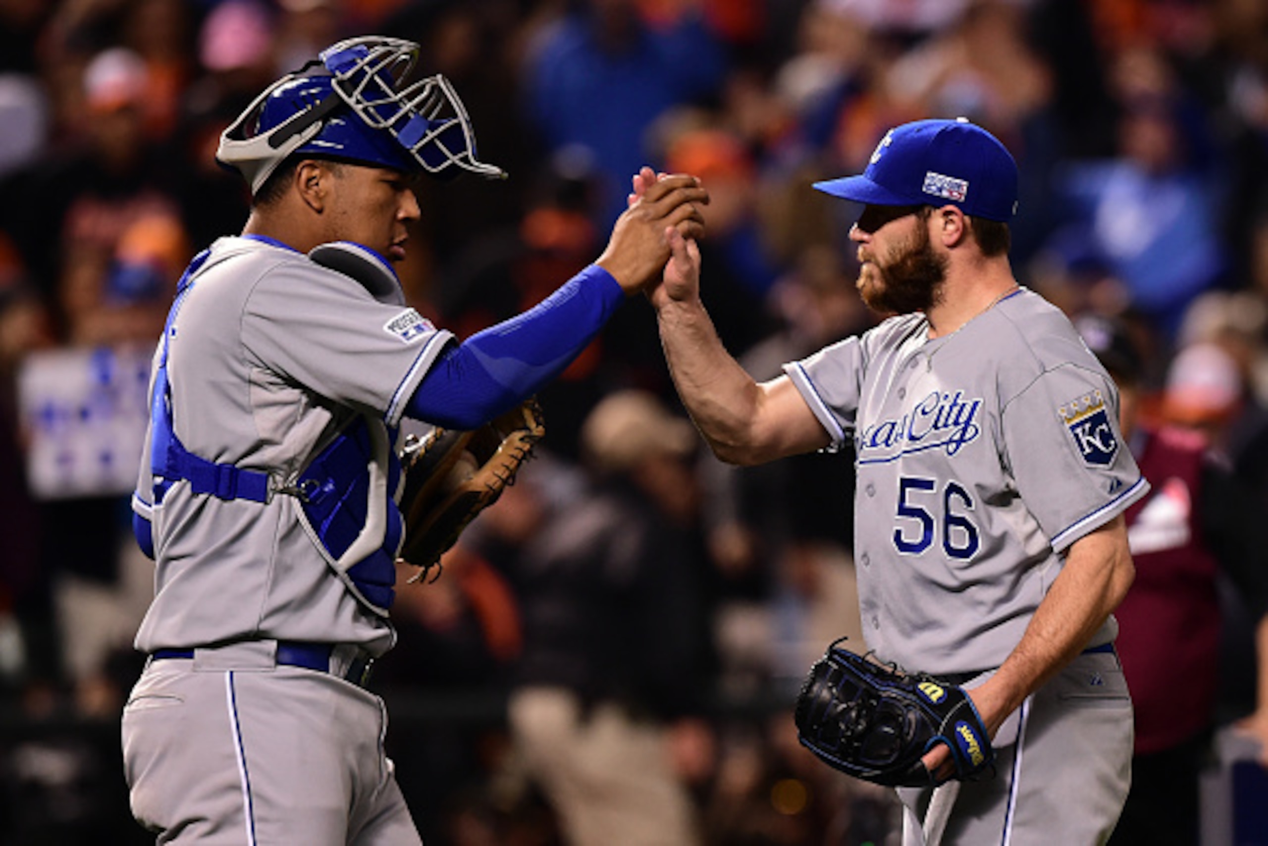 BALTIMORE, MD - OCTOBER 11:  Greg Holland #56 of the Kansas City Royals celebrates with teammate Salvador Perez #13 after closing out the ninth inning to defeat the Baltimore Orioles 6 to 4 in Game Two of the American League Championship Series at Oriole 