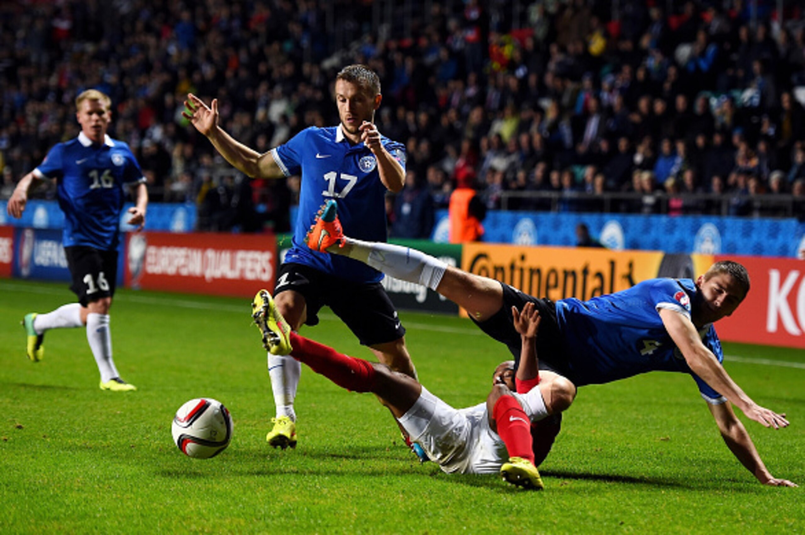 TALLINN, ESTONIA - OCTOBER 12:  Fabian Delph of England is tackled by Enar Jaager (L) of Estonia and Alo Barengrub (R) of Estonia during the EURO 2016 Qualifier match between Estonia and England at A. Le Coq Arena on October 12, 2014 in Tallinn, Estonia. 