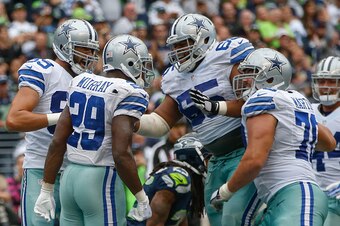 SEATTLE, WA - OCTOBER 12:  Running back DeMarco Murray #29 of the Dallas Cowboys celebrates with teammates after rushing for the winning touchdown in a 30-23 win over the Seattle Seahawks at CenturyLink Field on October 12, 2014 in Seattle, Washington.  (