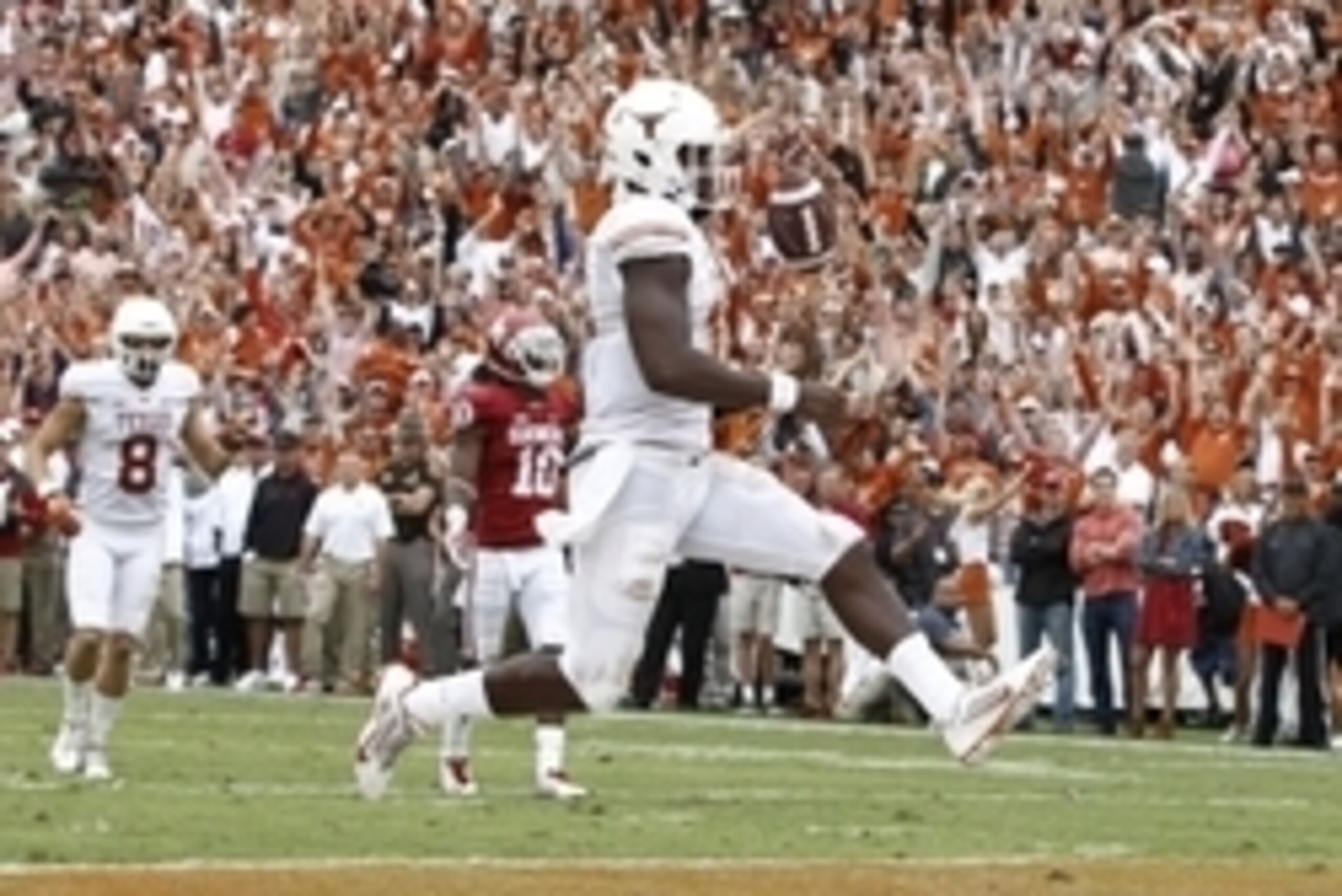 Oct 11, 2014; Dallas, TX, USA; Texas Longhorns quarterback Tyrone Swoopes (18) runs for a12 yard touchdown in the fourth quarter against the Oklahoma Sooners at the Cotton Bowl. Oklahoma beat Texas 31-26. Mandatory Credit: Tim Heitman-USA TODAY Sports