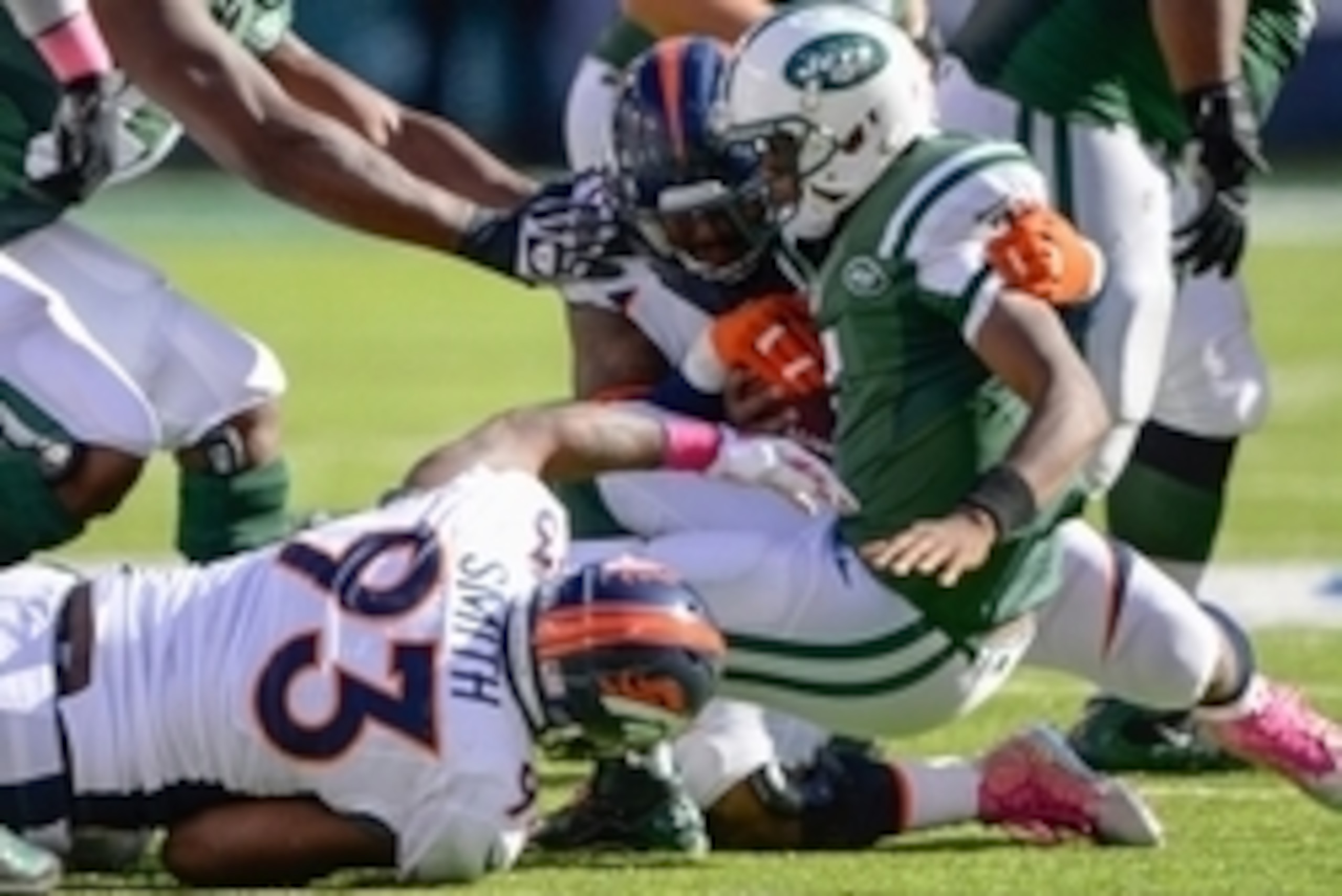 Oct 12, 2014; East Rutherford, NJ, USA; Denver Broncos outside linebacker Von Miller (58) and defensive end Quanterus Smith (93) sack New York Jets quarterback Geno Smith (7) during the second half at MetLife Stadium. Mandatory Credit: Robert Deutsch-USA 