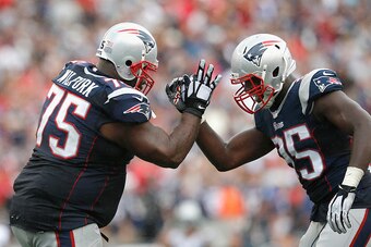 FOXBORO, MA - SEPTEMBER 21:  Vince Wilfork #75 of the New England Patriots high fives Chandler Jones #95 after intercepting the ball during the fourth quarter against the Oakland Raiders at Gillette Stadium on September 21, 2014 in Foxboro, Massachusetts.
