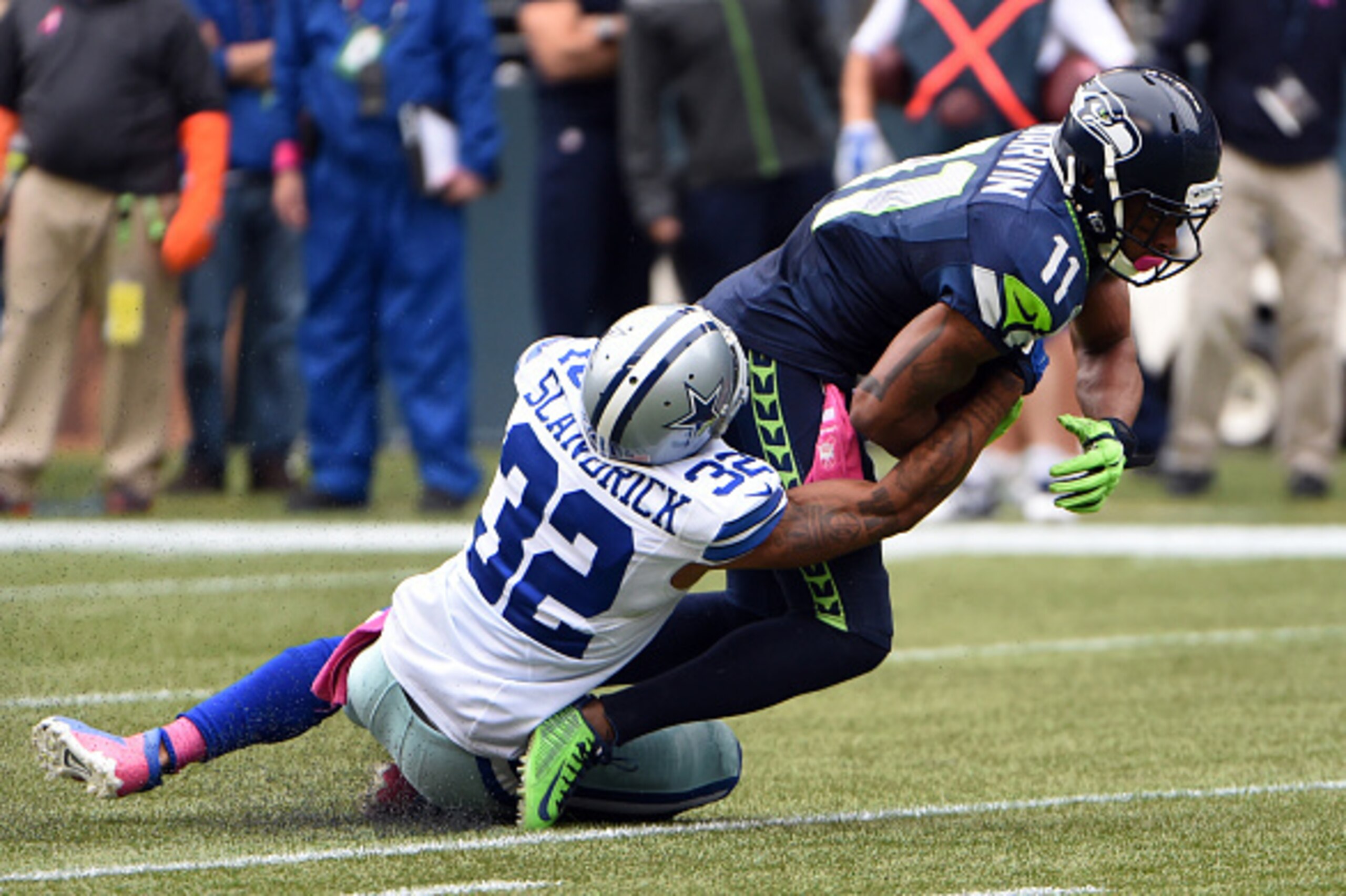 SEATTLE, WA - OCTBER 12: Wide receiver Percy Harvin #11 of the Seattle Seahawks is tackled by cornerback Orlando Scandrick #32 of the Dallas Cowboys during the third quarter of the game at CenturyLink Field on October 12, 2014 in Seattle,Washington. (Phot