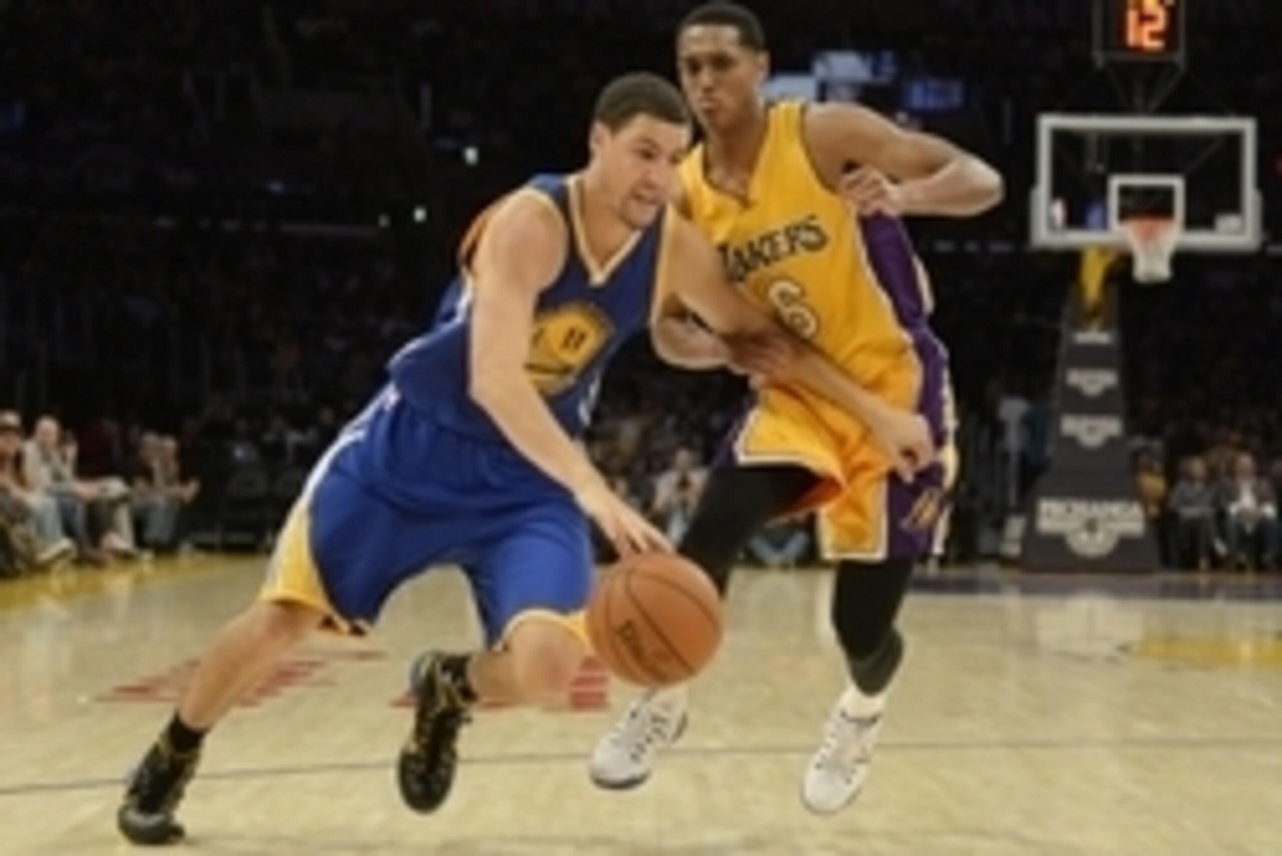 Oct 9, 2014; Los Angeles, CA, USA; Golden State Warriors guard Klay Thompson (11) drives against Los Angeles Lakers guard Jordan Clarkson (6) during the first half at Staples Center. Mandatory Credit: Richard Mackson-USA TODAY Sports