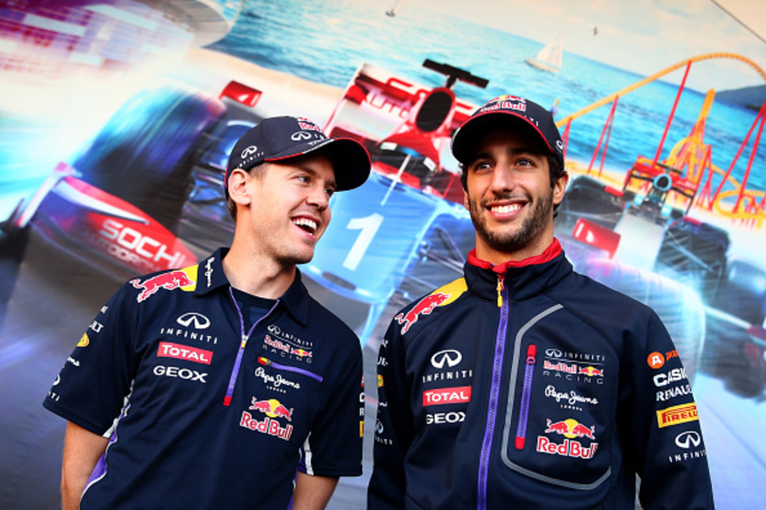 SOCHI, RUSSIA - OCTOBER 09:  Sebastian Vettel of Germany and Infiniti Red Bull Racing speaks with Daniel Ricciardo of Australia and Infiniti Red Bull Racing at a signing session during previews ahead of the Russian Formula One Grand Prix at Sochi Autodrom