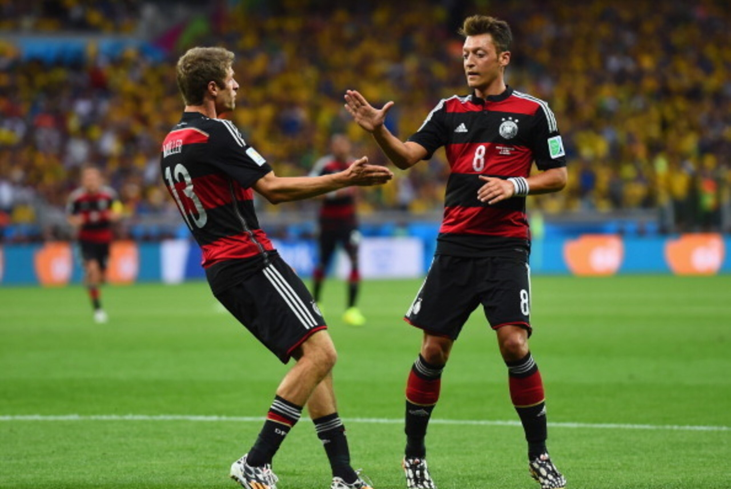 BELO HORIZONTE, BRAZIL - JULY 08: Thomas Mueller celebrates scoring his team's first goal with Mesut Oezil of Germany during the 2014 FIFA World Cup Brazil Semi Final match between Brazil and Germany at Estadio Mineirao on July 8, 2014 in Belo Horizonte, BELO HORIZONTE, BRAZIL - JULY 08: Thomas Mueller celebrates scoring his team's first goal with Mesut Oezil of Germany during the 2014 FIFA World Cup Brazil Semi Final match between Brazil and Germany at Estadio Mineirao on July 8, 2014 in Belo Horizonte,