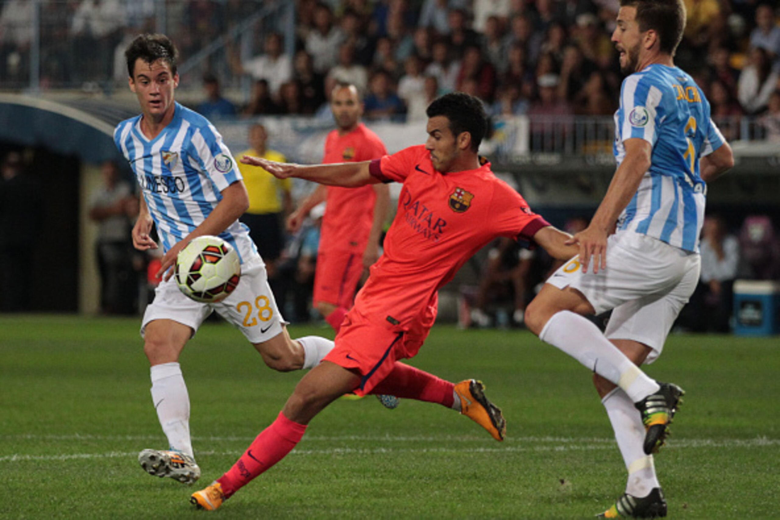 MALAGA, SPAIN - SEPTEMBER 24: Pedro Rodriguez of F.C. Barcelona (C), has a shot on goal under pressure from Juan Pablo Anor alias Juanpi (L) and Ignacio Camacho of Malaga CF (R) during the La Liga match between Malaga CF and FC Barcelona at La Rosaleda s MALAGA, SPAIN - SEPTEMBER 24: Pedro Rodriguez of F.C. Barcelona (C), has a shot on goal under pressure from Juan Pablo Anor alias Juanpi (L) and Ignacio Camacho of Malaga CF (R) during the La Liga match between Malaga CF and FC Barcelona at La Rosaleda s