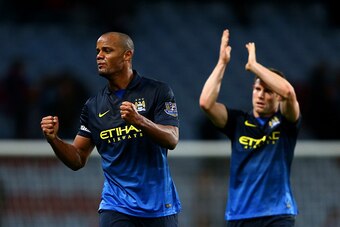 BIRMINGHAM, ENGLAND - OCTOBER 04:  Vincent Kompany and James Milner of Manchester City celebrate victory after the Barclays Premier League match between Aston Villa and Manchester City at Villa Park on October 4, 2014 in Birmingham, England.  (Photo by Ia
