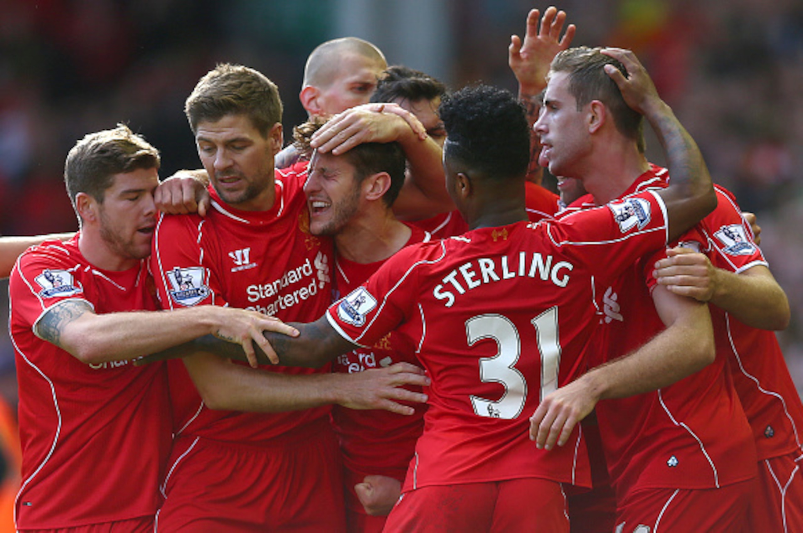 LIVERPOOL, ENGLAND - OCTOBER 04: Adam Lallana of Liverpool is congratulated by team mates on scoring the opening goal during the Barclays Premier League match between Liverpool and West Bromwich Albion at Anfield on October 4, 2014 in Liverpool, England. 