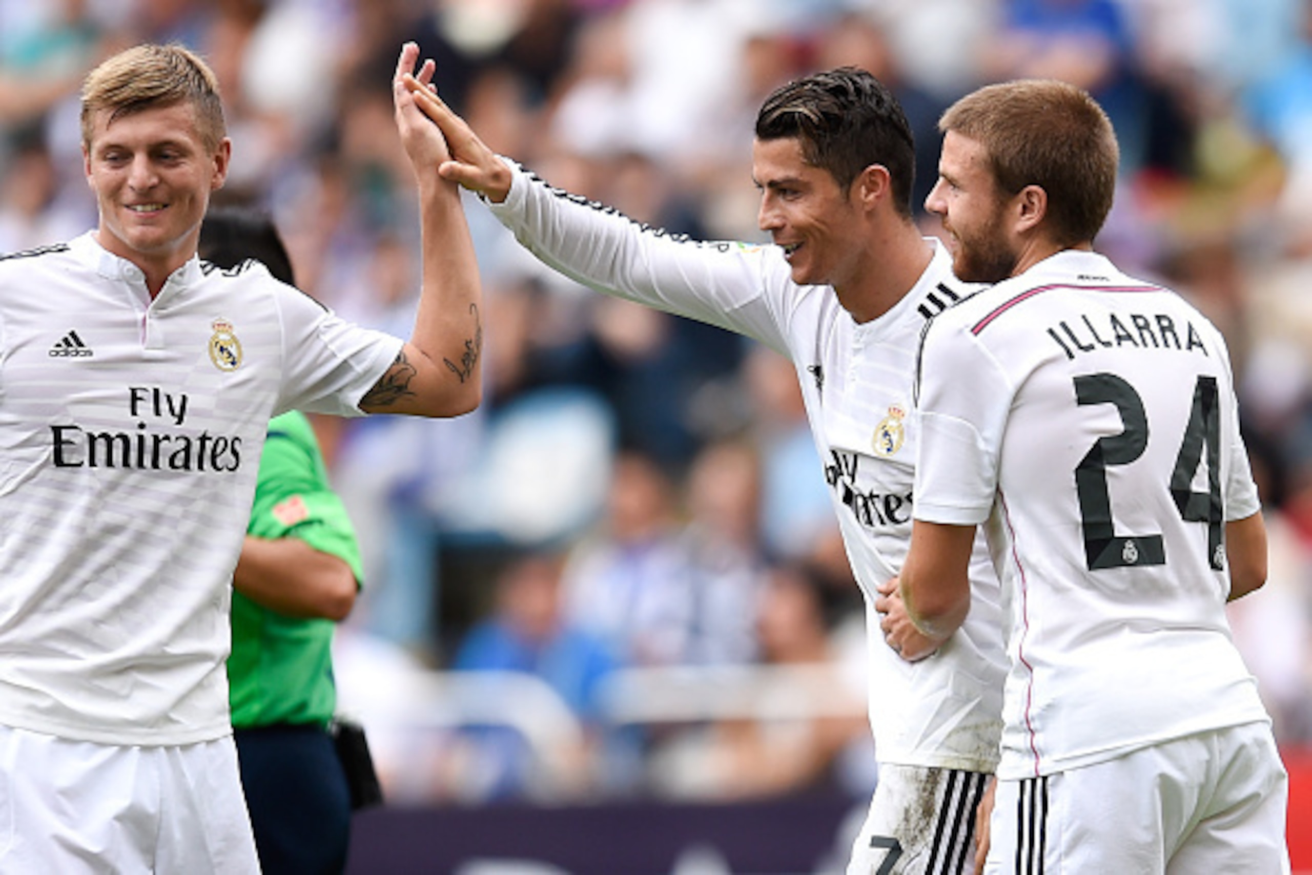 LA CORUNA, SPAIN - SEPTEMBER 20:  Cristiano Ronaldo of Real Madrid CF celebrates with his teammates Toni Kroos (L) and Asier Illarramendi after scoring his team's sixth goal his team's third goalduring the La Liga match between RC Deportivo La Coruna and 