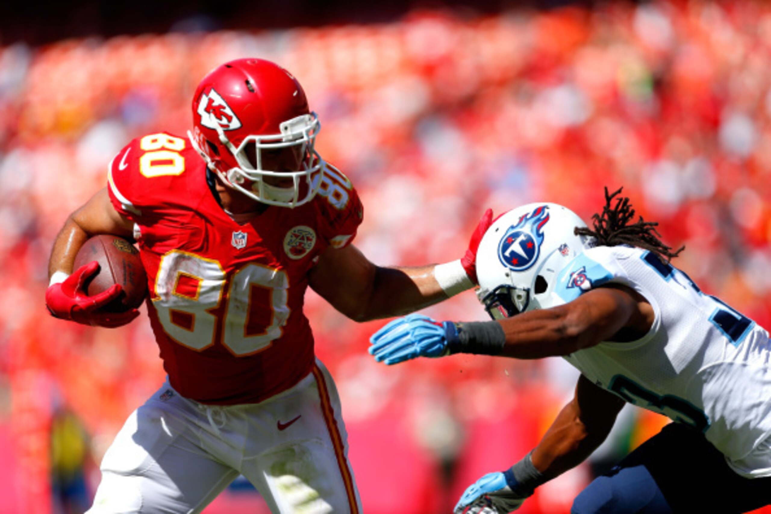KANSAS CITY, MO - SEPTEMBER 07:   Anthony Fasano #80 of the Kansas City Chiefs runs the ball against  Michael Griffin #33 of the Tennessee Titans during the second half at Arrowhead Stadium on September 7, 2014 in Kansas City, Missouri.  (Photo by Wesley 