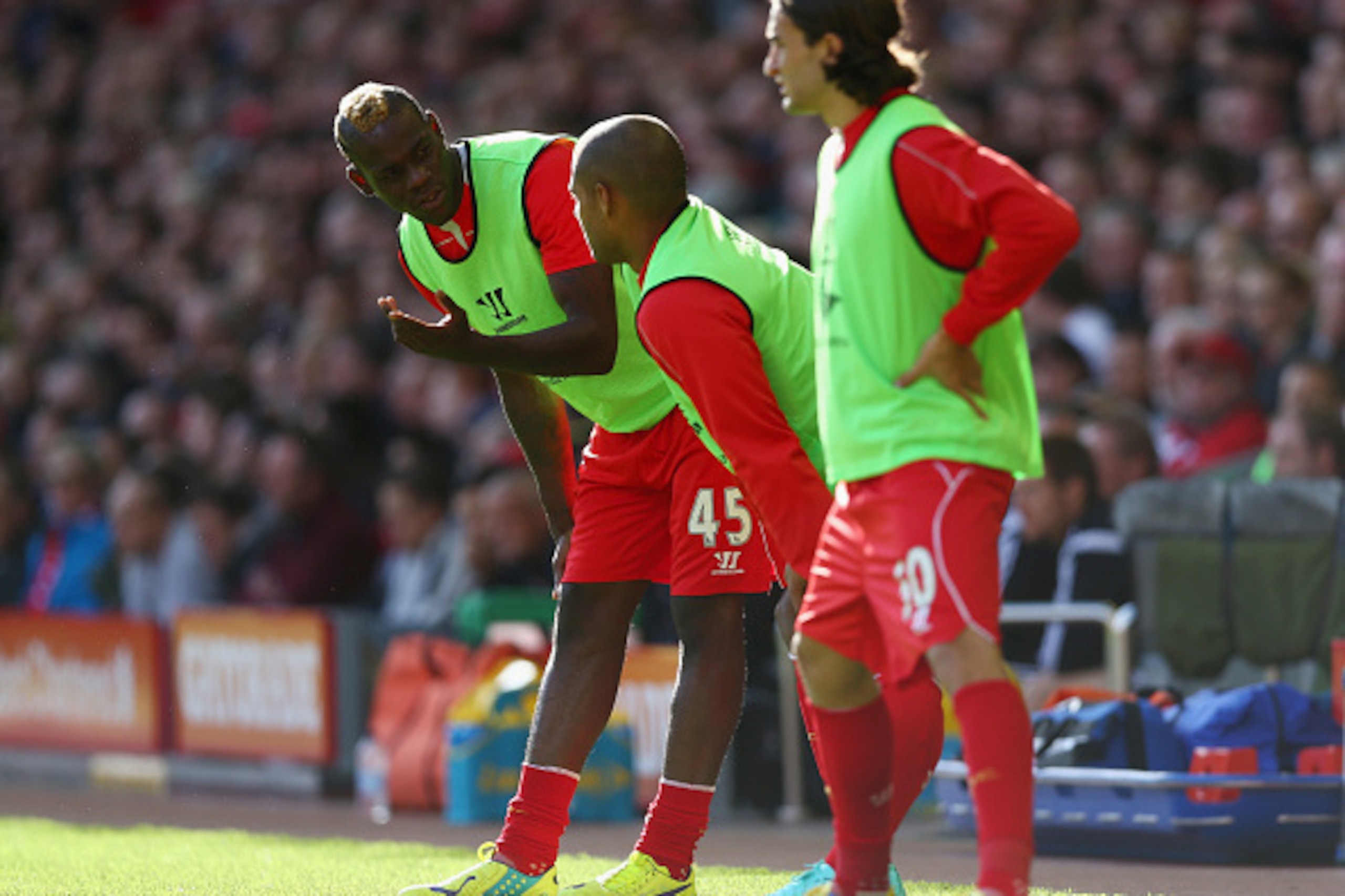 LIVERPOOL, ENGLAND - OCTOBER 04:  Mario Balotelli and Glen Johnson of Liverpool warm up on the touchline during the Barclays Premier League match between Liverpool and West Bromwich Albion at Anfield on October 4, 2014 in Liverpool, England.  (Photo by Cl
