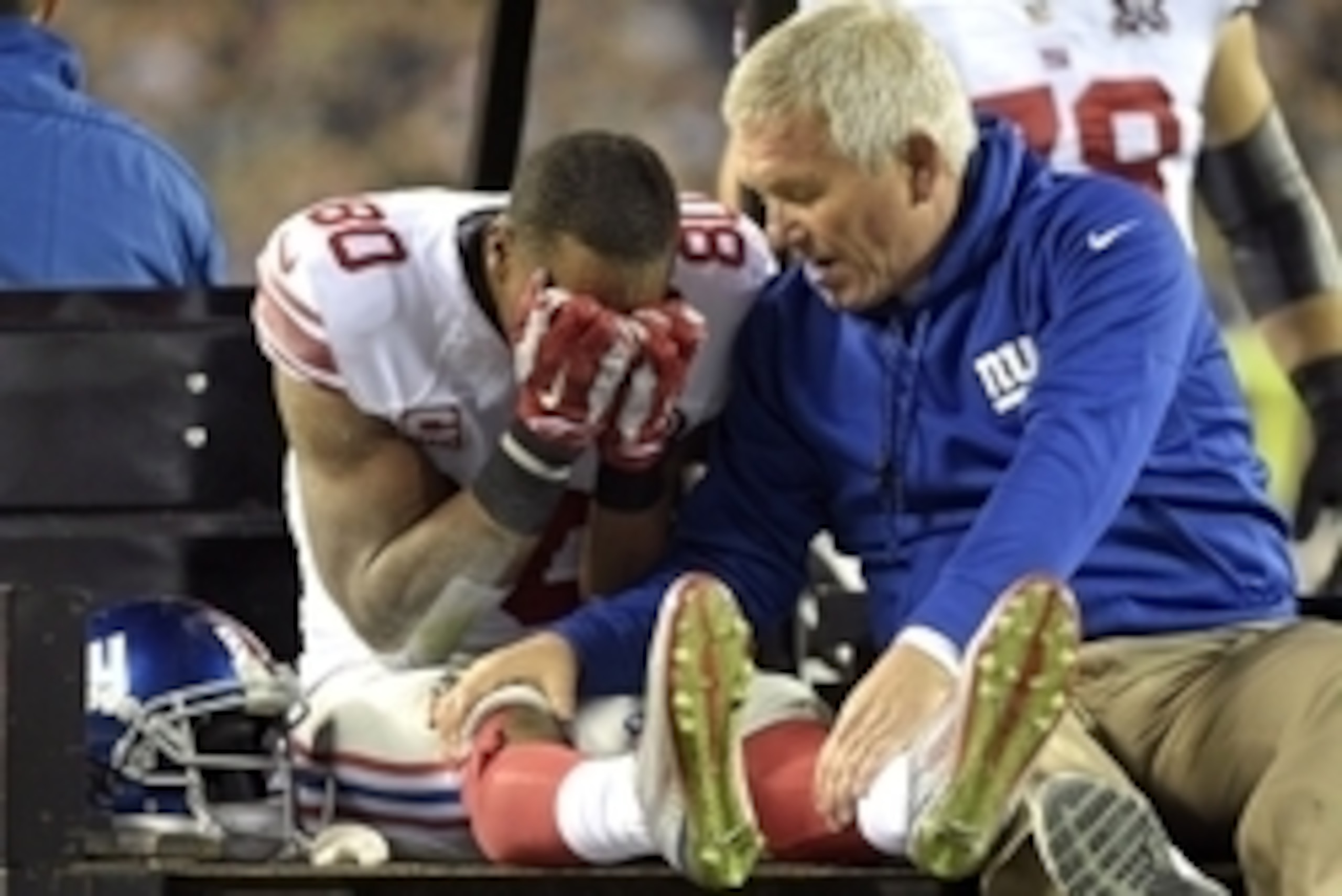 Oct 12, 2014; Philadelphia, PA, USA; New York Giants wide receiver Victor Cruz (80) with trainer Byron Hansen as he is carted off the field after an injury during the third quarter against the Philadelphia Eagles at Lincoln Financial Field. Mandatory Cred