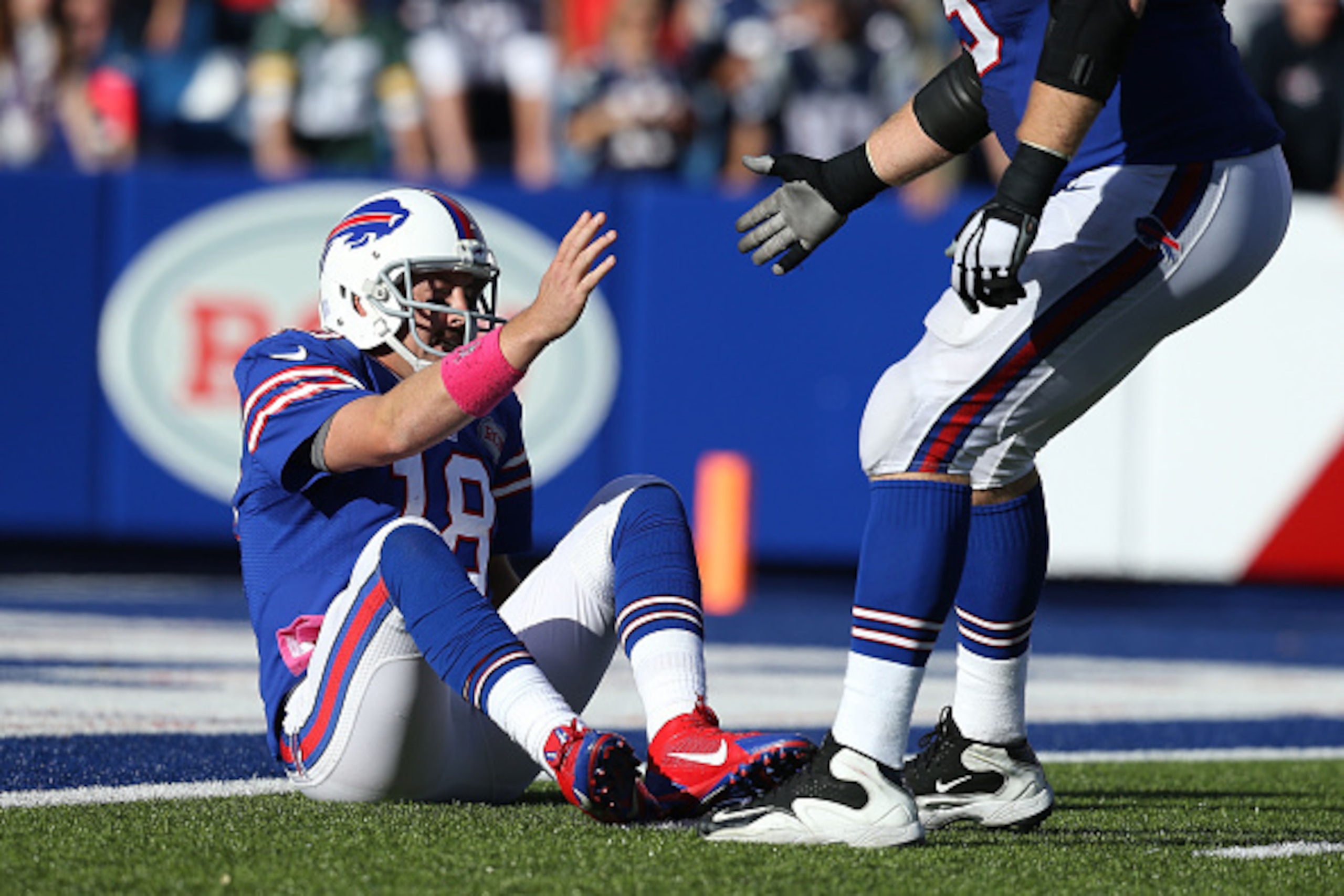 ORCHARD PARK, NY - OCTOBER 12: Kyle Orton #18 of the Buffalo Bills is helped up after being knocked down against the New England Patriots during the second half at Ralph Wilson Stadium on October 12, 2014 in Orchard Park, New York. (Photo by Brett Carl ORCHARD PARK, NY - OCTOBER 12: Kyle Orton #18 of the Buffalo Bills is helped up after being knocked down against the New England Patriots during the second half at Ralph Wilson Stadium on October 12, 2014 in Orchard Park, New York. (Photo by Brett Carl