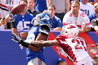 Sep 14, 2014; East Rutherford, NJ, USA; New York Giants wide wreceiver Rueben Randle (82) catches a touchdown pass in front of Arizona Cardinals corner back Patrick Peterson (21) during the second quarter at MetLife Stadium. Mandatory Credit: Brad Penner-