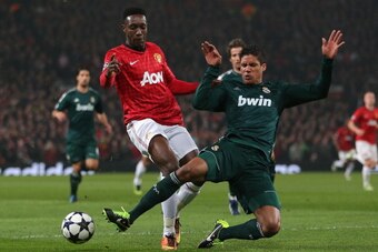 MANCHESTER, ENGLAND - MARCH 05:  Danny Welbeck of Manchester United is challenged by Raphael Varane of Real Madrid during the UEFA Champions League Round of 16 Second leg match between Manchester United and Real Madrid at Old Trafford on March 5, 2013 in 