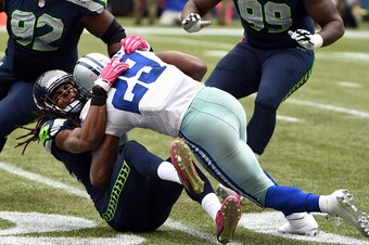 SEATTLE, WA - OCTBER 12: Running back DeMarco Murray #29 of the Dallas Cowboys runs over cornerback Richard Sherman #25 of the Seattle Seahawksduring the third quarter of the game at CenturyLink Field on October 12, 2014 in Seattle,Washington. (Photo by S
