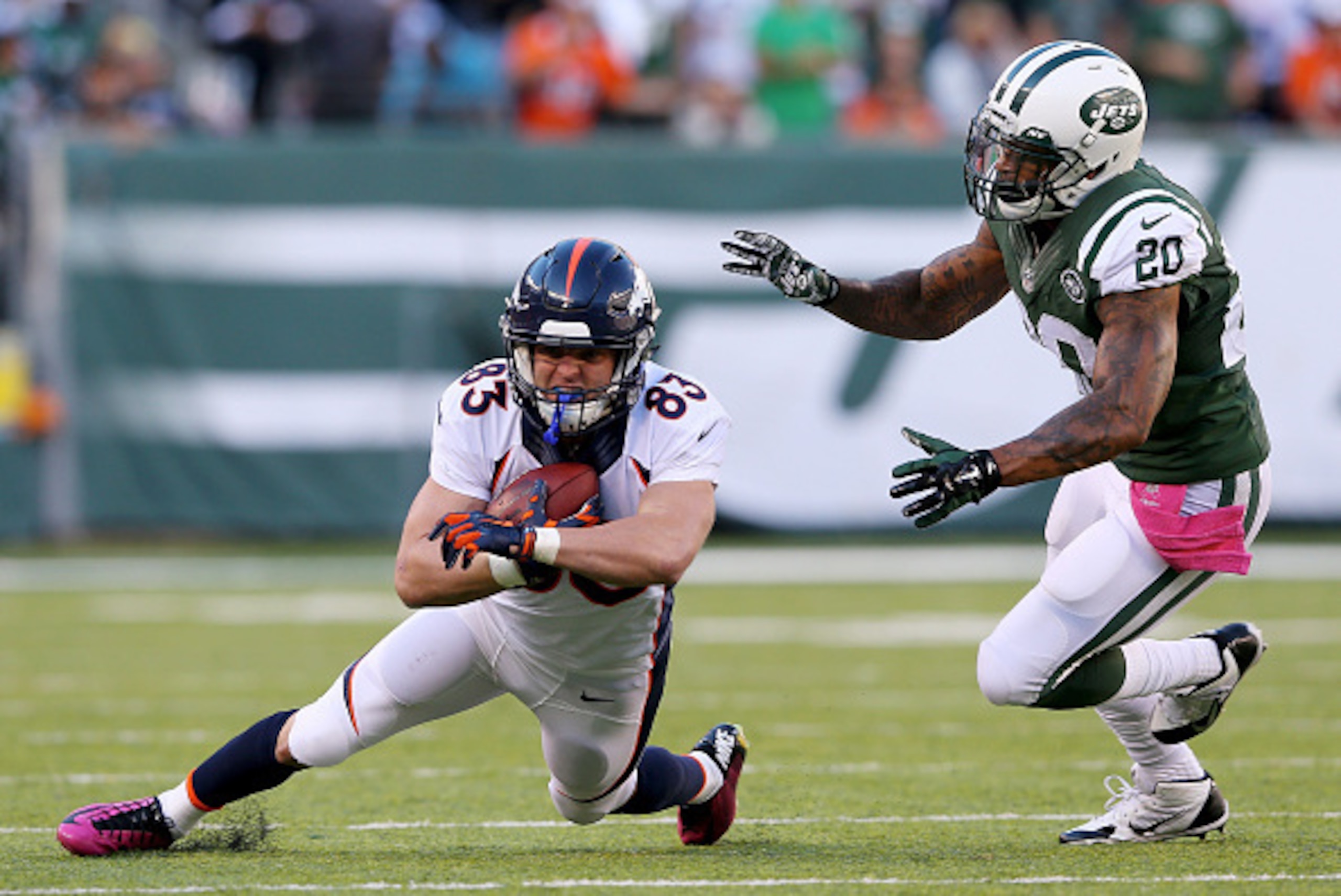 EAST RUTHERFORD, NJ - OCTOBER 12:  Wes Welker #83 of the Denver Broncos carries the ball as Kyle Wilson #20 of the New York Jets defends on October 12, 2014 at MetLife Stadium in East Rutherford, New Jersey.  (Photo by Elsa/Getty Images)