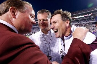 Mississippi State AD Scott Stricklin (center) with head coach Dan Mullen (right)