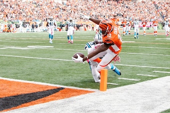 CINCINNATI, OH - OCTOBER 12:  Mohamed Sanu #12 of the Cincinnati Bengals dives to score a touchdown while being hit by Melvin White #23 of the Carolina Panthers during the fourth quarter at Paul Brown Stadium on October 12, 2014 in Cincinnati, Ohio. Cinci
