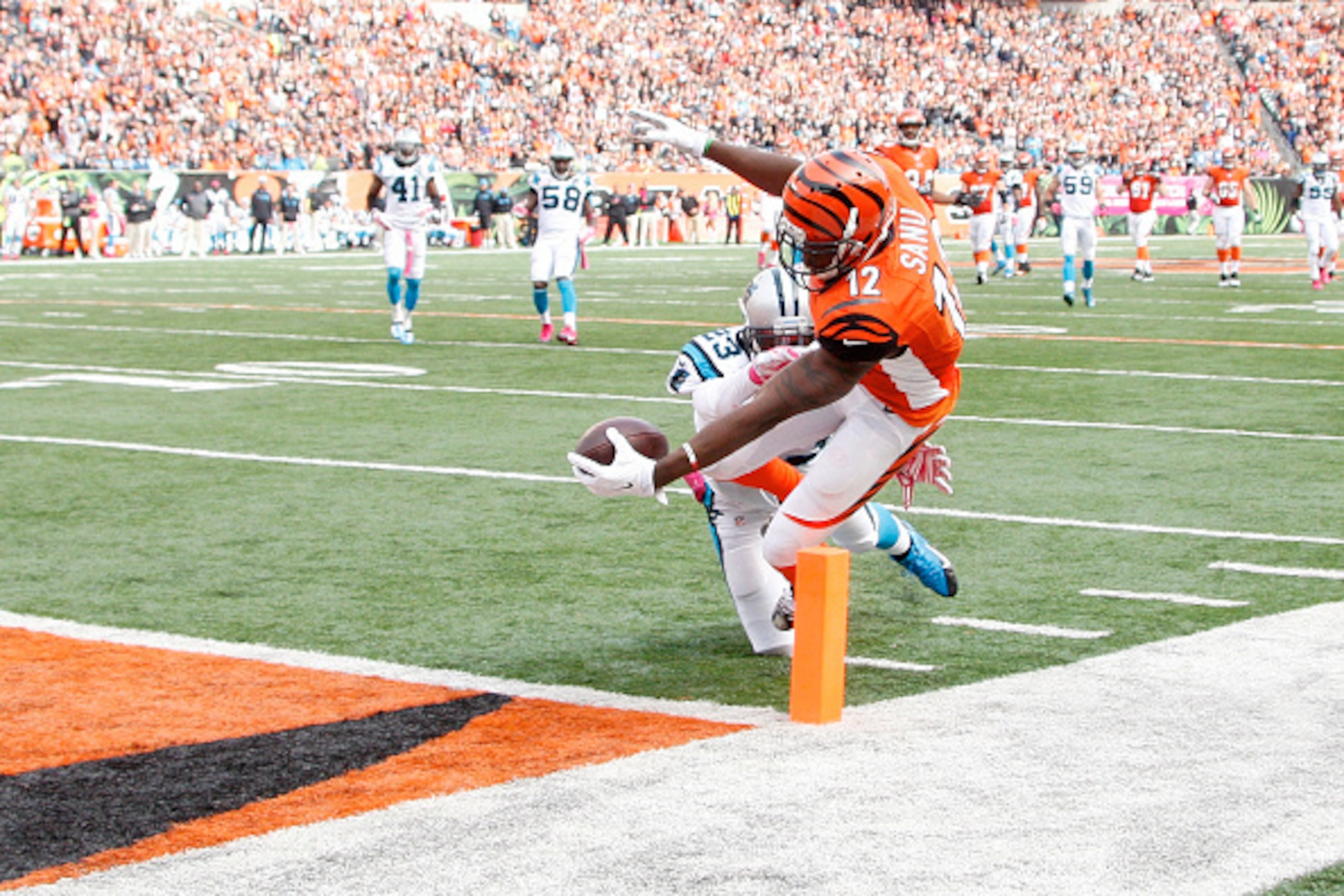 CINCINNATI, OH - OCTOBER 12: Mohamed Sanu #12 of the Cincinnati Bengals dives to score a touchdown while being hit by Melvin White #23 of the Carolina Panthers during the fourth quarter at Paul Brown Stadium on October 12, 2014 in Cincinnati, Ohio. Cinci CINCINNATI, OH - OCTOBER 12: Mohamed Sanu #12 of the Cincinnati Bengals dives to score a touchdown while being hit by Melvin White #23 of the Carolina Panthers during the fourth quarter at Paul Brown Stadium on October 12, 2014 in Cincinnati, Ohio. Cinci