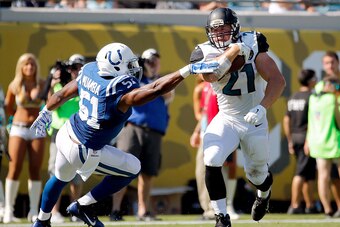 JACKSONVILLE, FL - SEPTEMBER 21: Toby Gerhart #21 of the Jacksonville Jaguars runs with the ball against Henoc Muamba #51 of the Indianapolis Colts during the second half of the game at EverBank Field on September 21, 2014 in Jacksonville, Florida.  (Phot