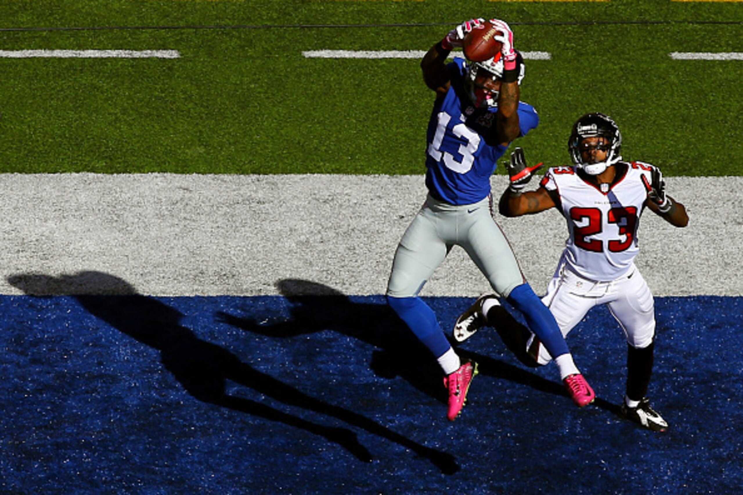 EAST RUTHERFORD, NJ - OCTOBER 05:  Wide receiver Odell Beckham #13 of the New York Giants scores a 15 yard touchdown in the fourth quarter against cornerback Robert Alford #23 of the Atlanta Falcons during their game at MetLife Stadium on October 5, 2014 
