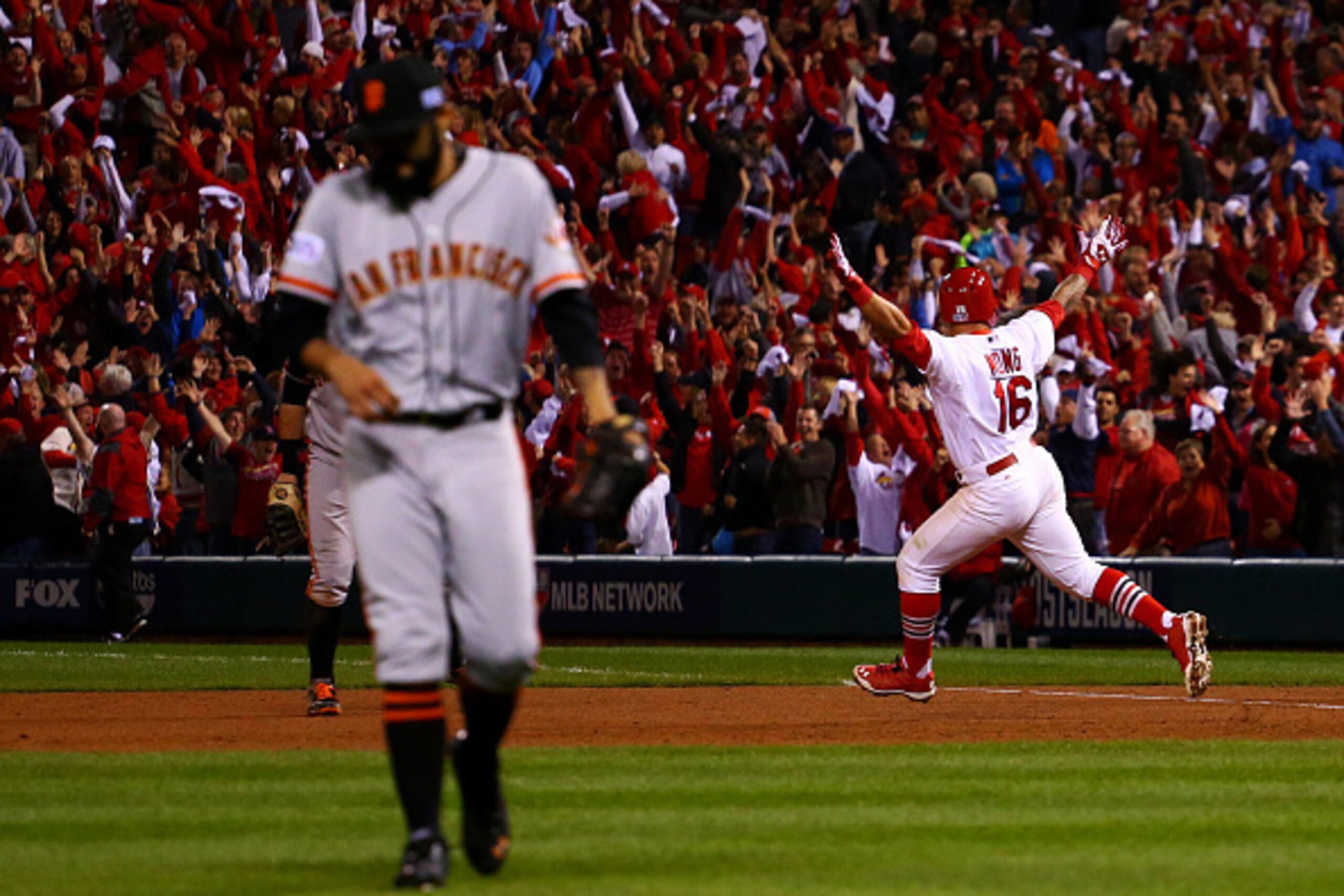 ST LOUIS, MO - OCTOBER 12:  Kolten Wong #16 of the St. Louis Cardinals celebrates his solo home run in the ninth inning to give the St. Louis Cardinals the 5 to 4 win over the San Francisco Giants during Game Two of the National League Championship Series