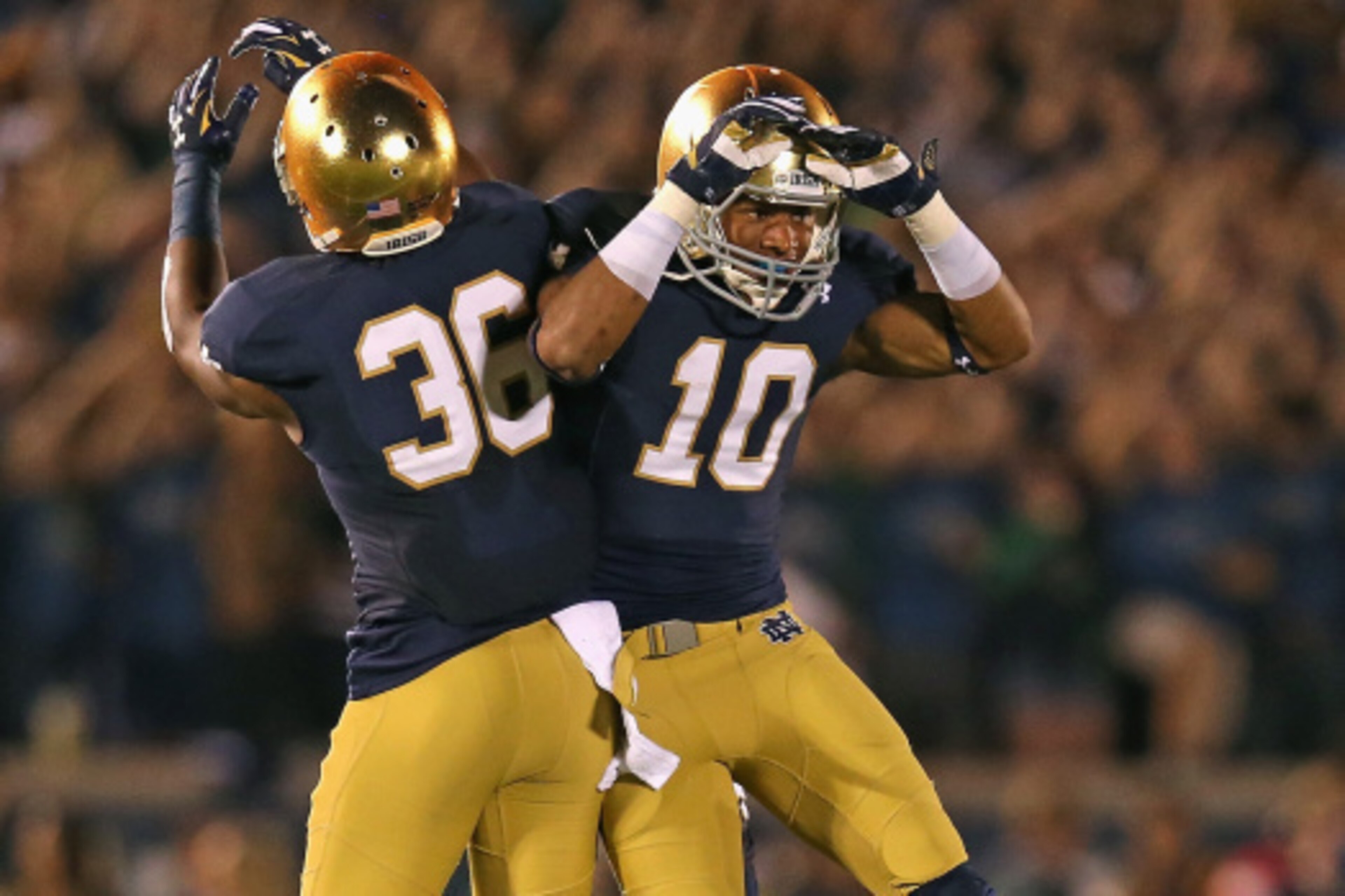 SOUTH BEND, IN - SEPTEMBER 06: Max Redfield #10 and Cole Luke #36 of the Notre Dame Fighting Irish celebrate Redfield's interception against the Michigan Wolverines at Notre Dame Stadium on September 6, 2014 in South Bend, Indiana. (Photo by Jonathan Dani
