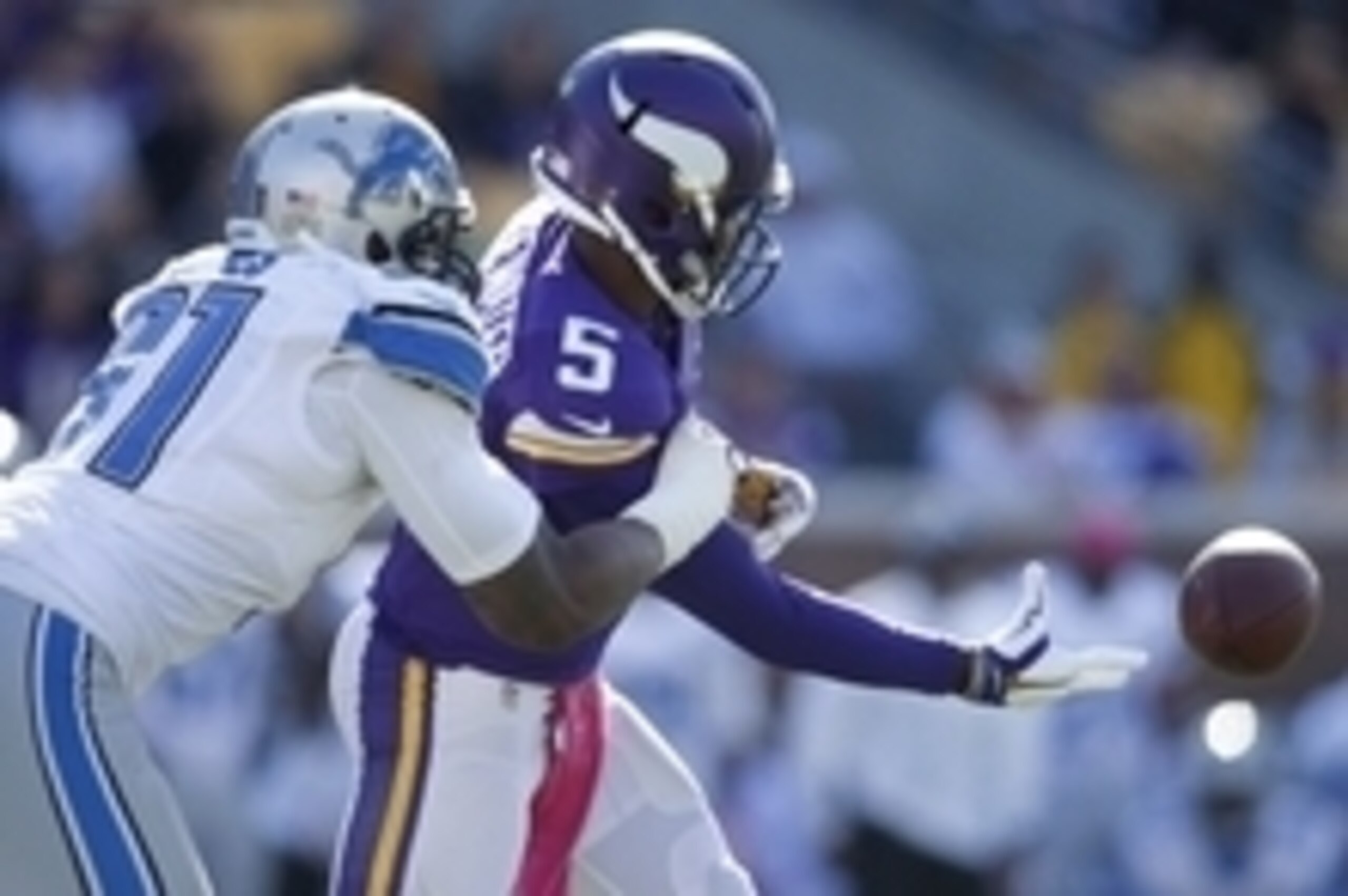 Oct 12, 2014; Minneapolis, MN, USA; Minnesota Vikings quarterback Teddy Bridgewater (5) passes underhand as Detroit Lions defensive end Jason Jones (91) pressures him in the fourth quarter at TCF Bank Stadium. The Lions win 17-3. Mandatory Credit: Bruce K