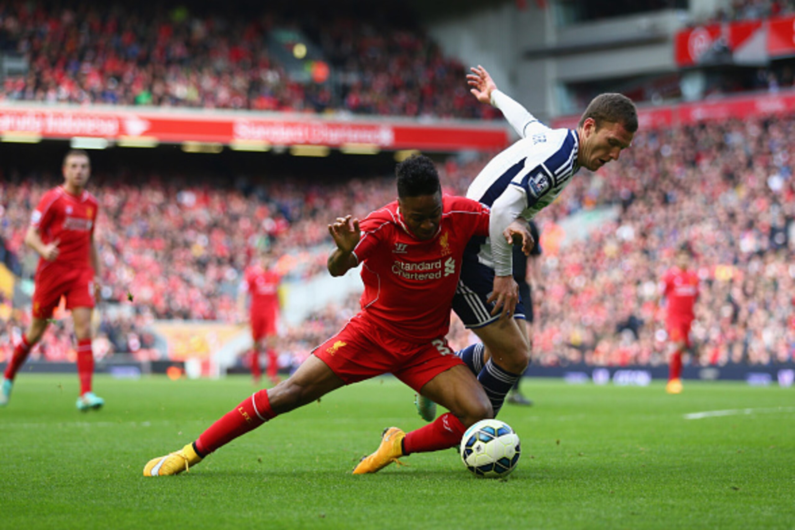 LIVERPOOL, ENGLAND - OCTOBER 04: Raheem Sterling of Liverpool and Craig Gardner of West Brom battle for the ball during the Barclays Premier League match between Liverpool and West Bromwich Albion at Anfield on October 4, 2014 in Liverpool, England. (Pho LIVERPOOL, ENGLAND - OCTOBER 04: Raheem Sterling of Liverpool and Craig Gardner of West Brom battle for the ball during the Barclays Premier League match between Liverpool and West Bromwich Albion at Anfield on October 4, 2014 in Liverpool, England. (Pho