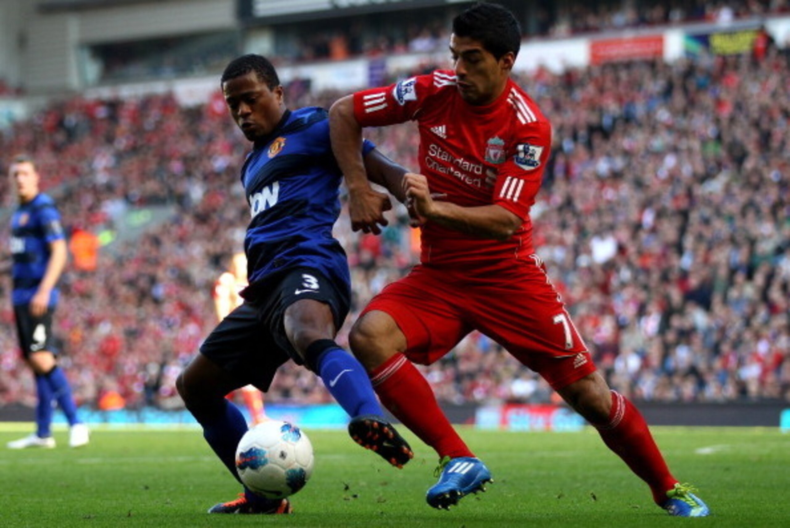 LIVERPOOL, ENGLAND - OCTOBER 15:  Luis Suarez of Liverpool tussles for posesssion with Patrice Evra of Manchester United during the Barclays Premier League match between Liverpool and Manchester United at Anfield on October 15, 2011 in Liverpool, England.