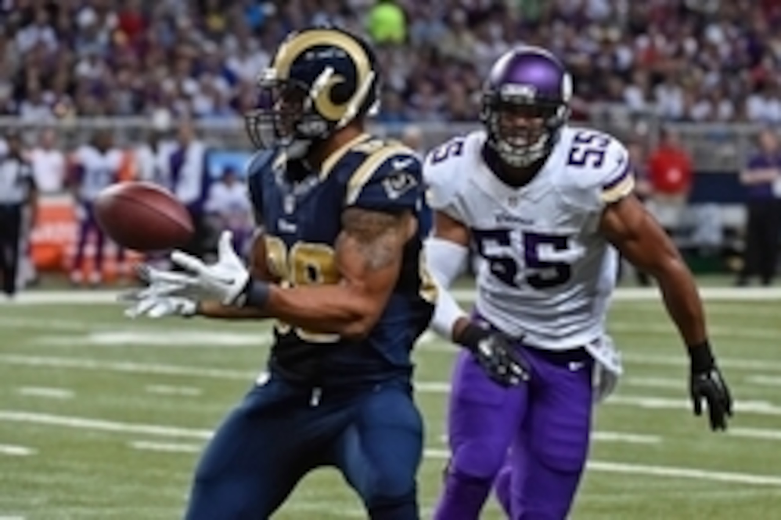 Sep 7, 2014; St. Louis, MO, USA; St. Louis Rams tight end Lance Kendricks (88) makes a catch under pressure from Minnesota Vikings outside linebacker Anthony Barr (55) during the second half at the Edward Jones Dome. The Minnesota Vikings defeat St. Louis