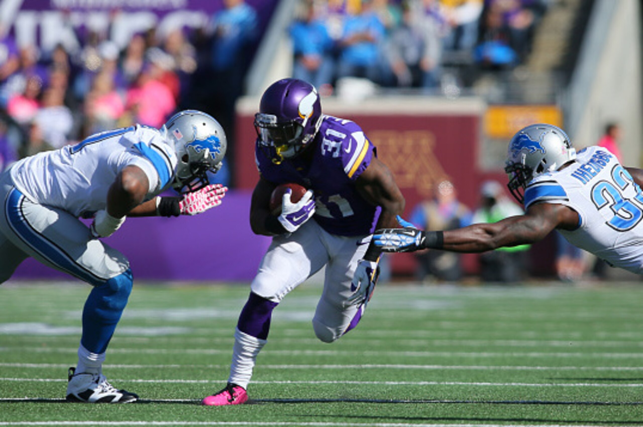 MINNEAPOLIS, MN - OCTOBER 12:  Jerick McKinnon #31 of the Minnesota Vikings carries the ball against James Ihedigbo #32 of the Detroit Lions during the fourth quarter on October 12, 2014 at TCF Bank Stadium in Minneapolis, Minnesota. (Photo by Adam Bettch