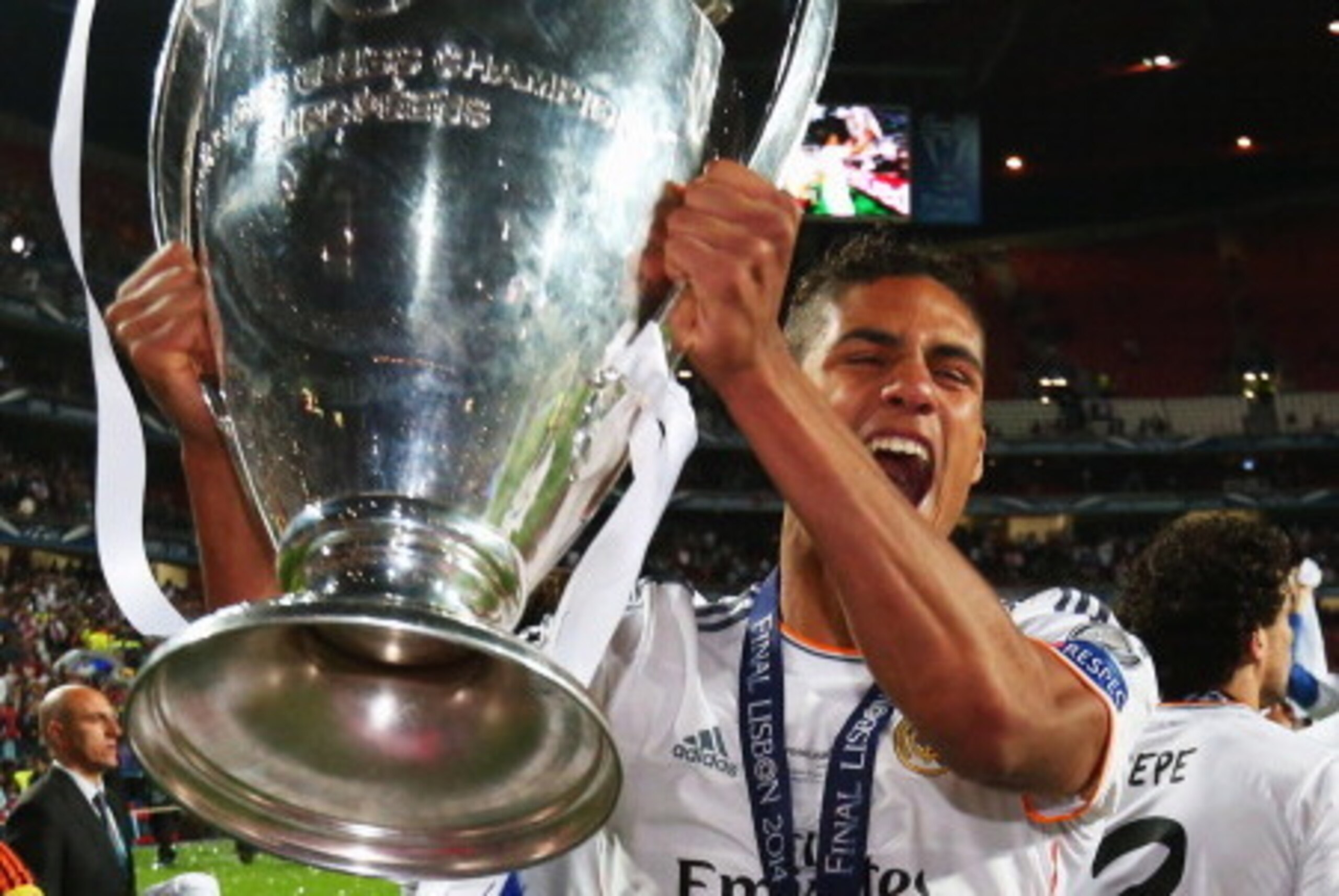 LISBON, PORTUGAL - MAY 24:  Raphael Varane of Real Madrid celebrates victory with the trophy after the UEFA Champions League Final between Real Madrid and Atletico de Madrid at Estadio da Luz on May 24, 2014 in Lisbon, Portugal.  (Photo by Alex Livesey/Ge