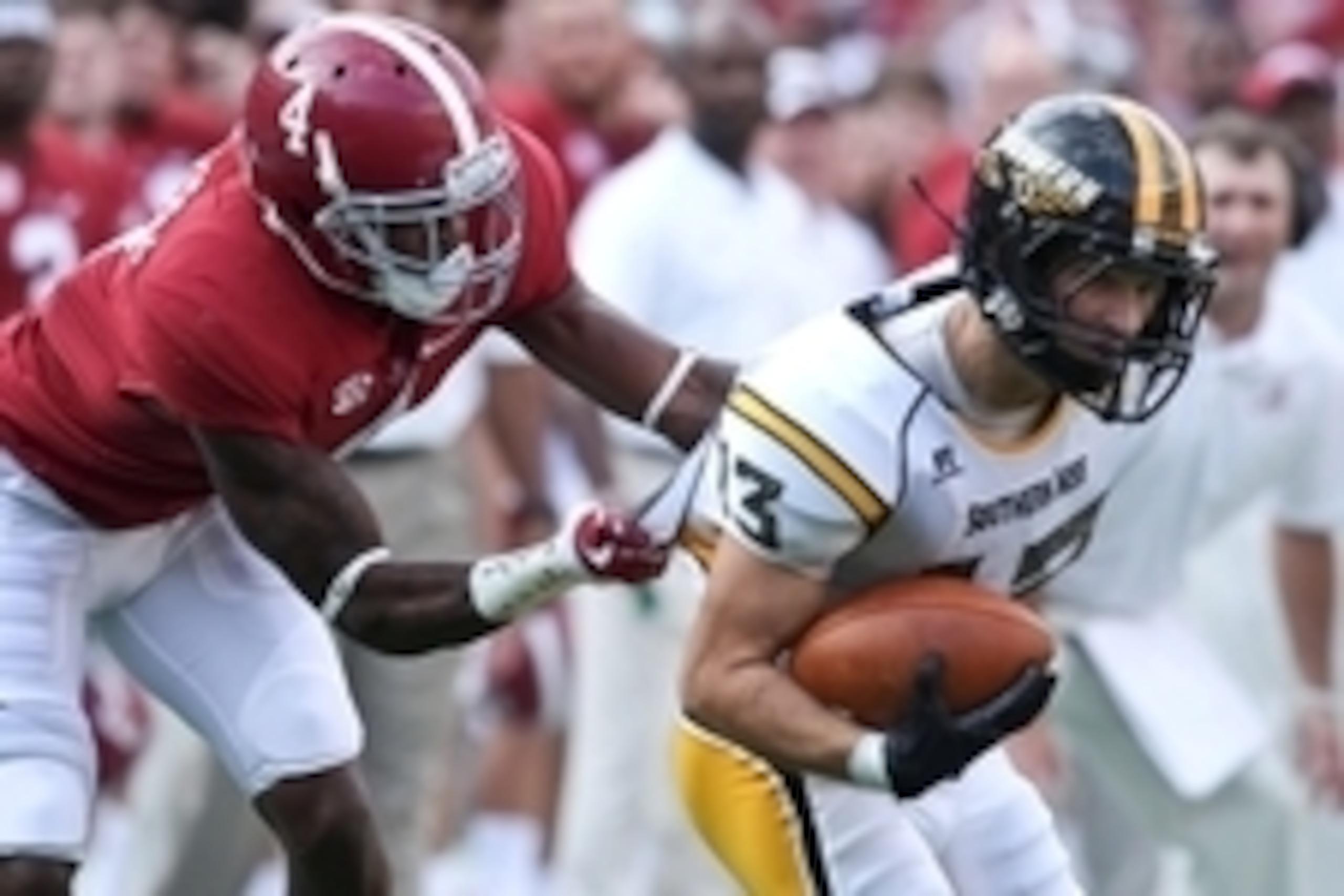Sep 13, 2014; Tuscaloosa, AL, USA; Alabama Crimson Tide defensive back Eddie Jackson (4) grabs the shirt of Southern Miss Golden Eagles wide receiver Casey Martin (13) at Bryant-Denny Stadium. Mandatory Credit: Marvin Gentry-USA TODAY Sports