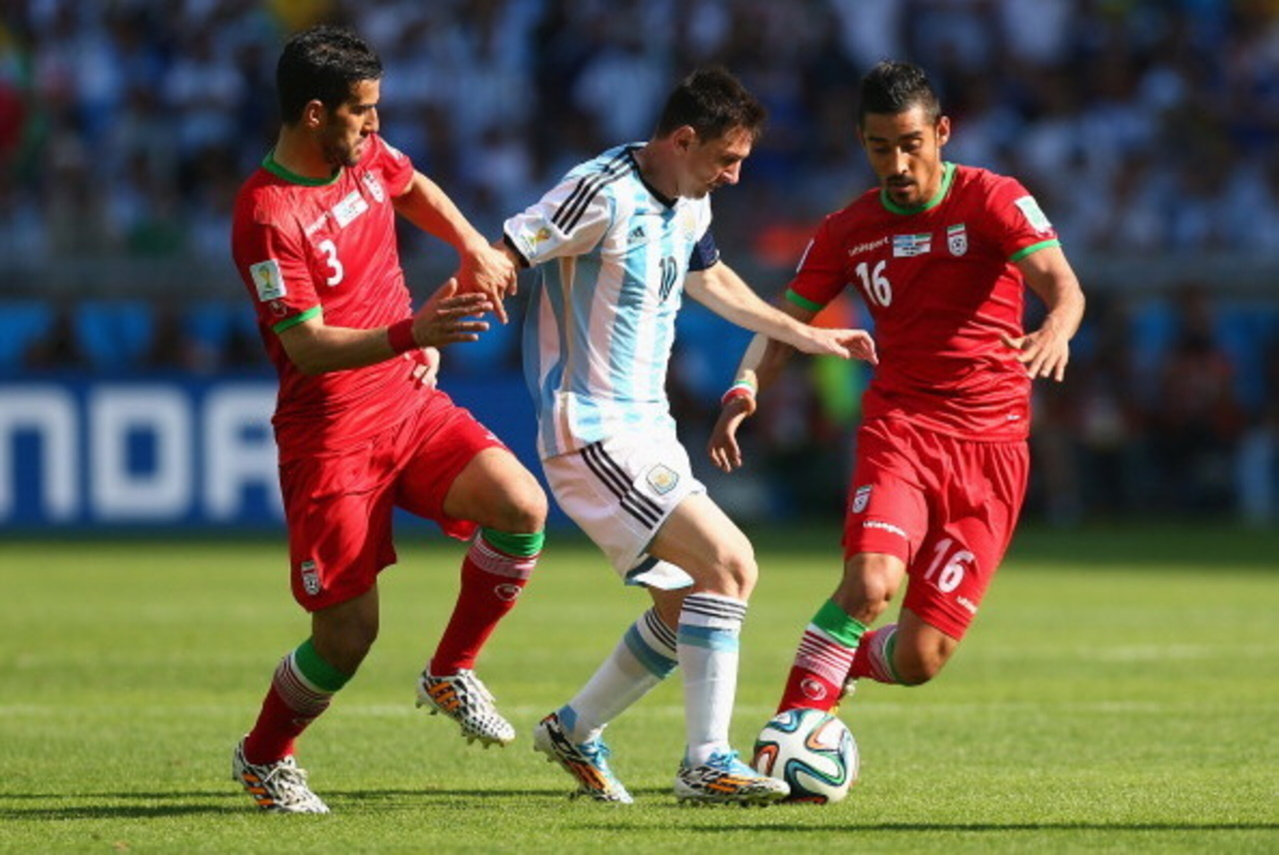 BELO HORIZONTE, BRAZIL - JUNE 21: Lionel Messi of Argentina is challenged by Ehsan Haji Safi (L) and Reza Ghoochannejhad of Iran during the 2014 FIFA World Cup Brazil Group F match between Argentina and Iran at Estadio Mineirao on June 21, 2014 in Belo Ho