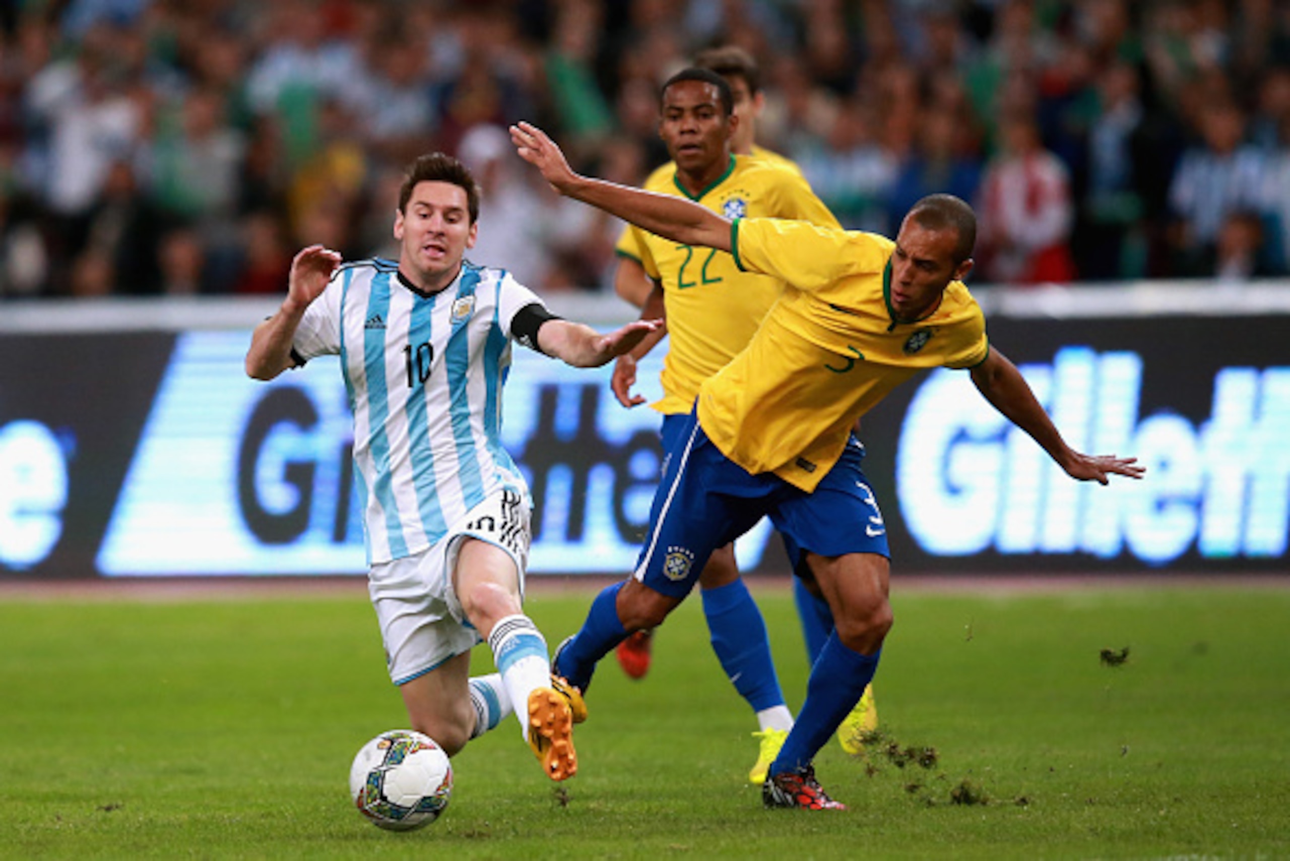 BEIJING, CHINA - OCTOBER 11:  Mranda of Brazil (Right) competes the ball with Lionel Messi of Argentina (Left) during Super Clasico de las Americas between Argentina and Brazil at Beijing National Stadium on October 11, 2014 in Beijing, China.  (Photo by 