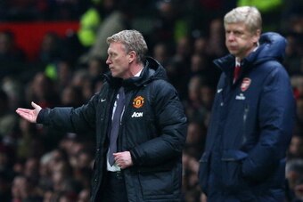 MANCHESTER, ENGLAND - NOVEMBER 10:  Manchester United Manager David Moyes reacts as Arsenal Manager Arsene Wenger looks on during the Barclays Premier League match between Manchester United and Arsenal at Old Trafford on November 10, 2013 in Manchester, E