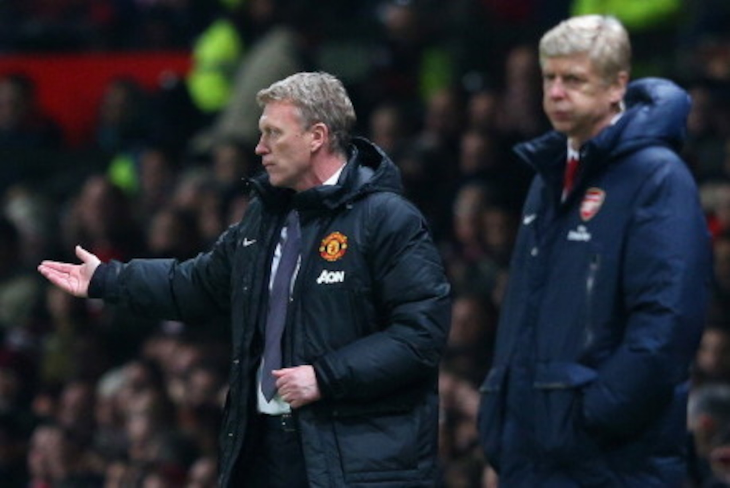 MANCHESTER, ENGLAND - NOVEMBER 10:  Manchester United Manager David Moyes reacts as Arsenal Manager Arsene Wenger looks on during the Barclays Premier League match between Manchester United and Arsenal at Old Trafford on November 10, 2013 in Manchester, E
