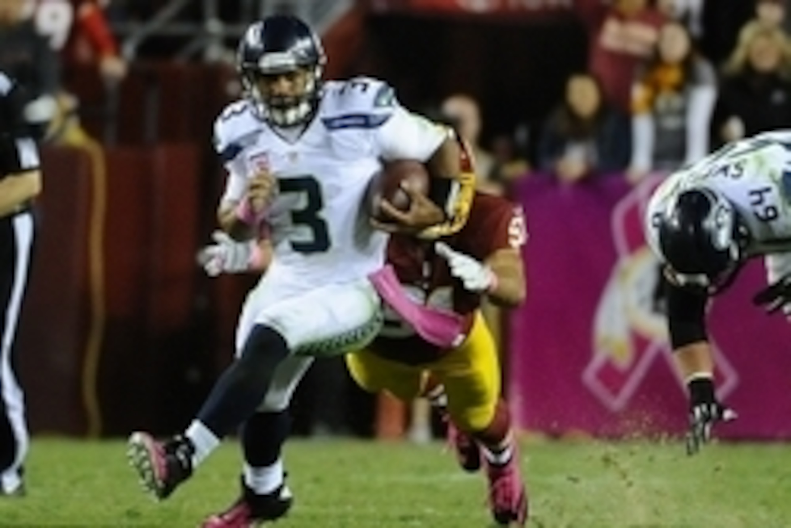 Oct 6, 2014; Landover, MD, USA; Seattle Seahawks quarterback Russell Wilson (3) runs with the ball as Washington Redskins outside linebacker Ryan Kerrigan (91) chases during the second half at FedEx Field. The Seahawks won 27-17. Mandatory Credit: Brad Mi Oct 6, 2014; Landover, MD, USA; Seattle Seahawks quarterback Russell Wilson (3) runs with the ball as Washington Redskins outside linebacker Ryan Kerrigan (91) chases during the second half at FedEx Field. The Seahawks won 27-17. Mandatory Credit: Brad Mi