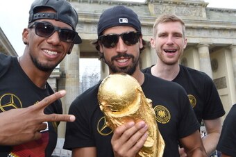 BERLIN, GERMANY - JULY 15: Jerome Boateng, Sami Khedira and  Per Mertersacker celebrate during the German team victory ceremony on July 15, 2014 in Berlin, Germany. Germany won the 2014 FIFA World Cup Brazil match against Argentina in Rio de Janeiro on Ju